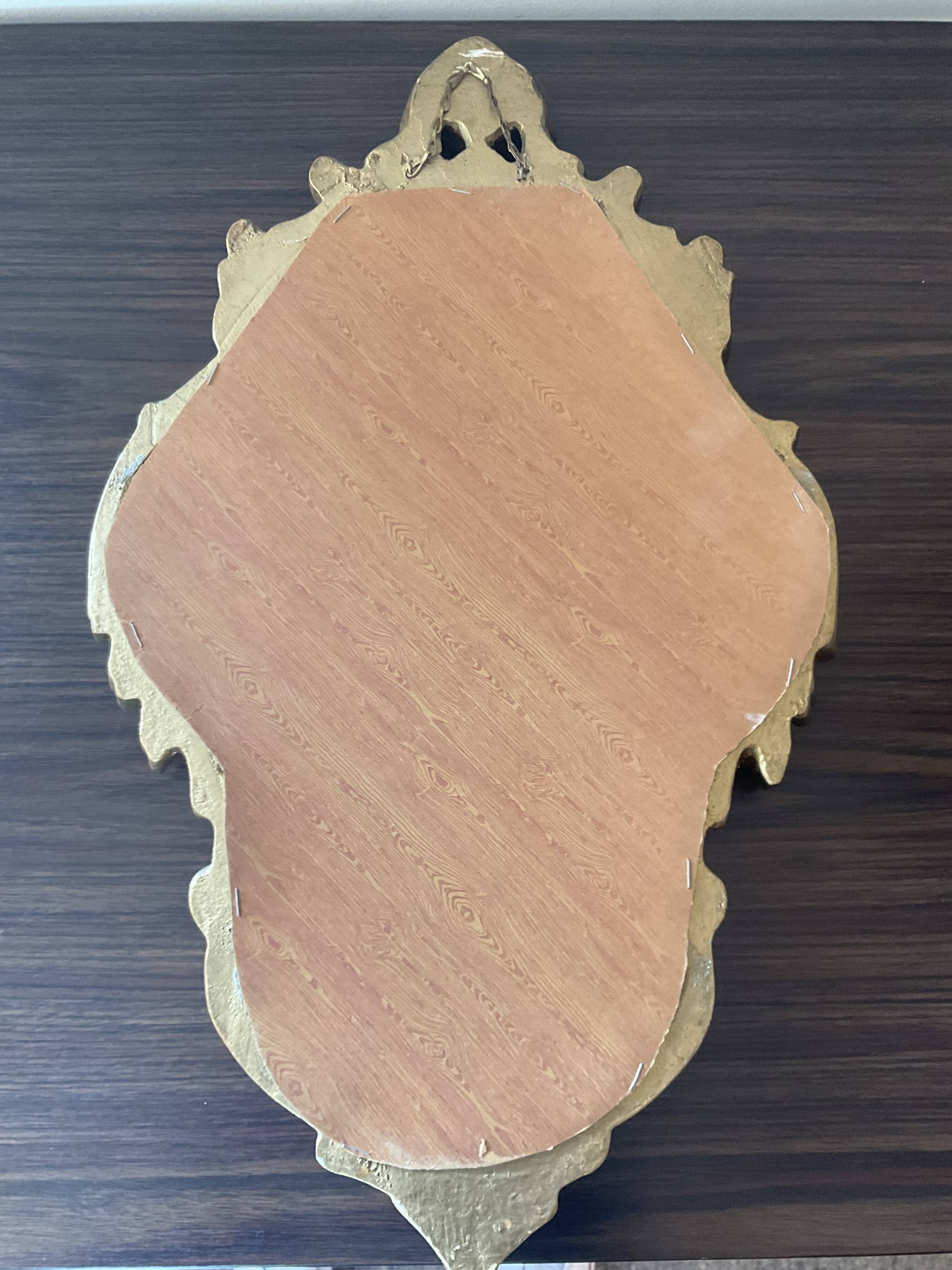 Old italian mirror in gilded plaster with leaf