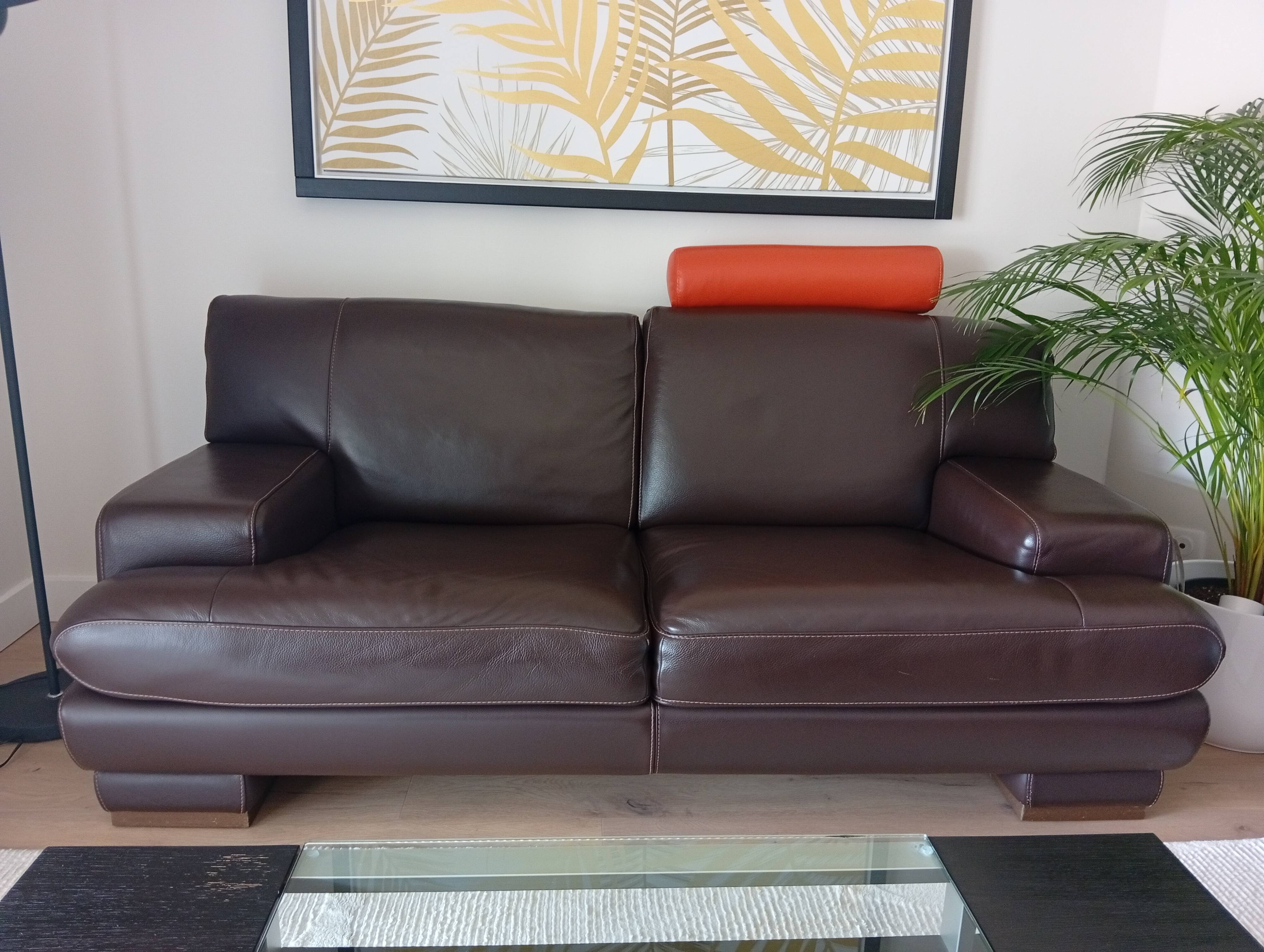 Two brown leather Crozatier two-and-a-half-seater sofas.