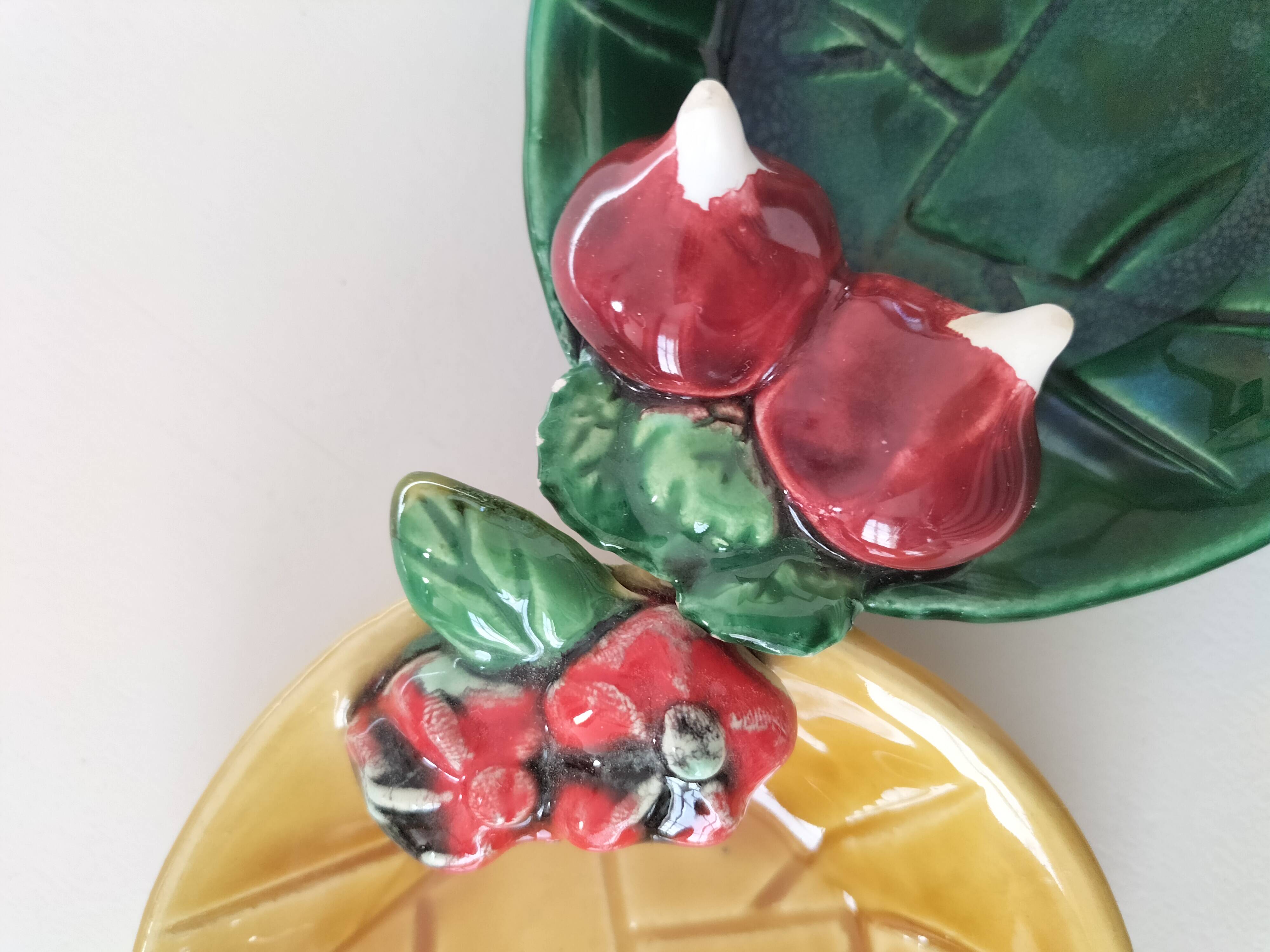 Two relief bowls with leaf designs, radishes, and tomatoes.