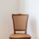 Oval dining table and 6 caned chairs in Louis XVI style made of wood.