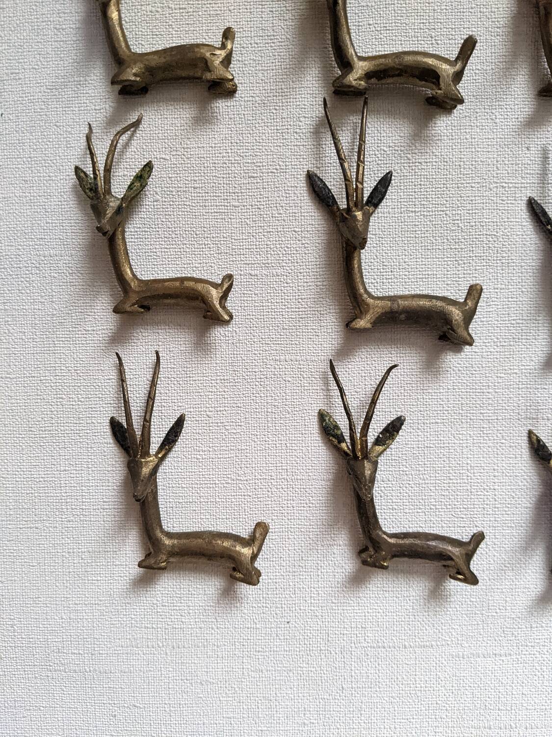 12 bronze and brass knife rests, African art, gazelles