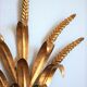 Applies "wheat sheaf" gold metal