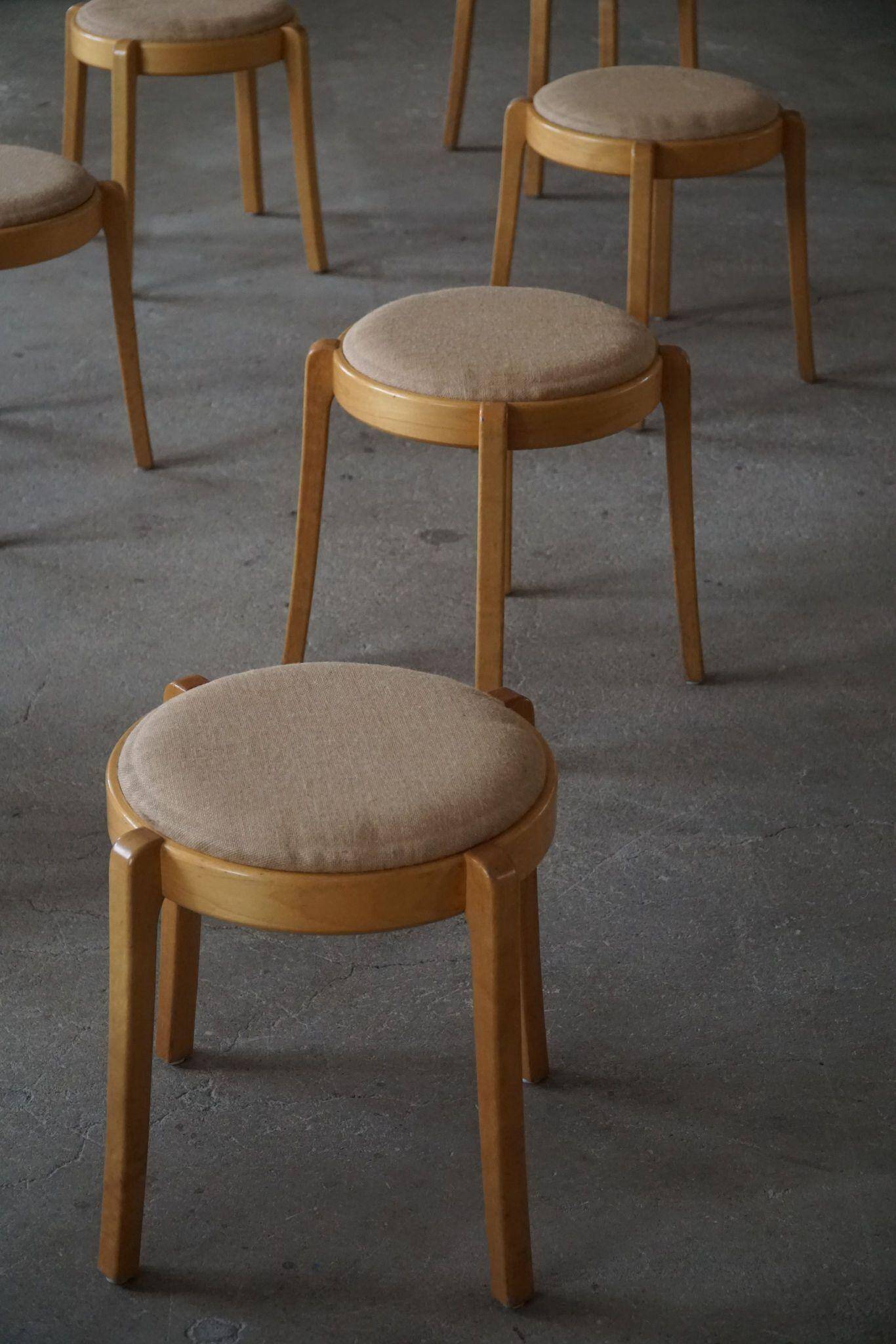 Set of 14 modern Swedish stackable stools in birch and hessian, 1980s.
