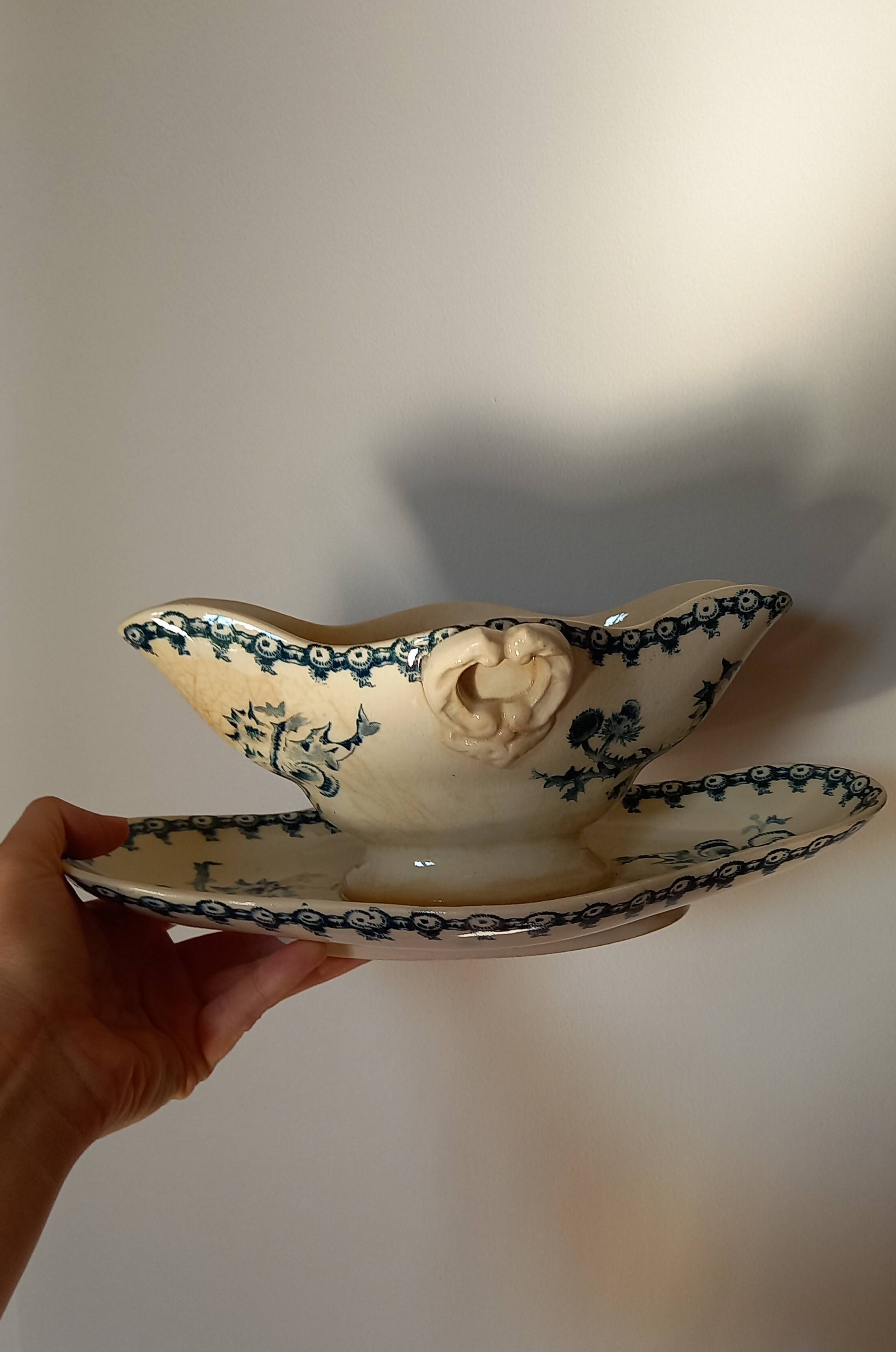 Old gravy boat on frame in terre de fer earthenware by gien, “chardons” model in blue-green