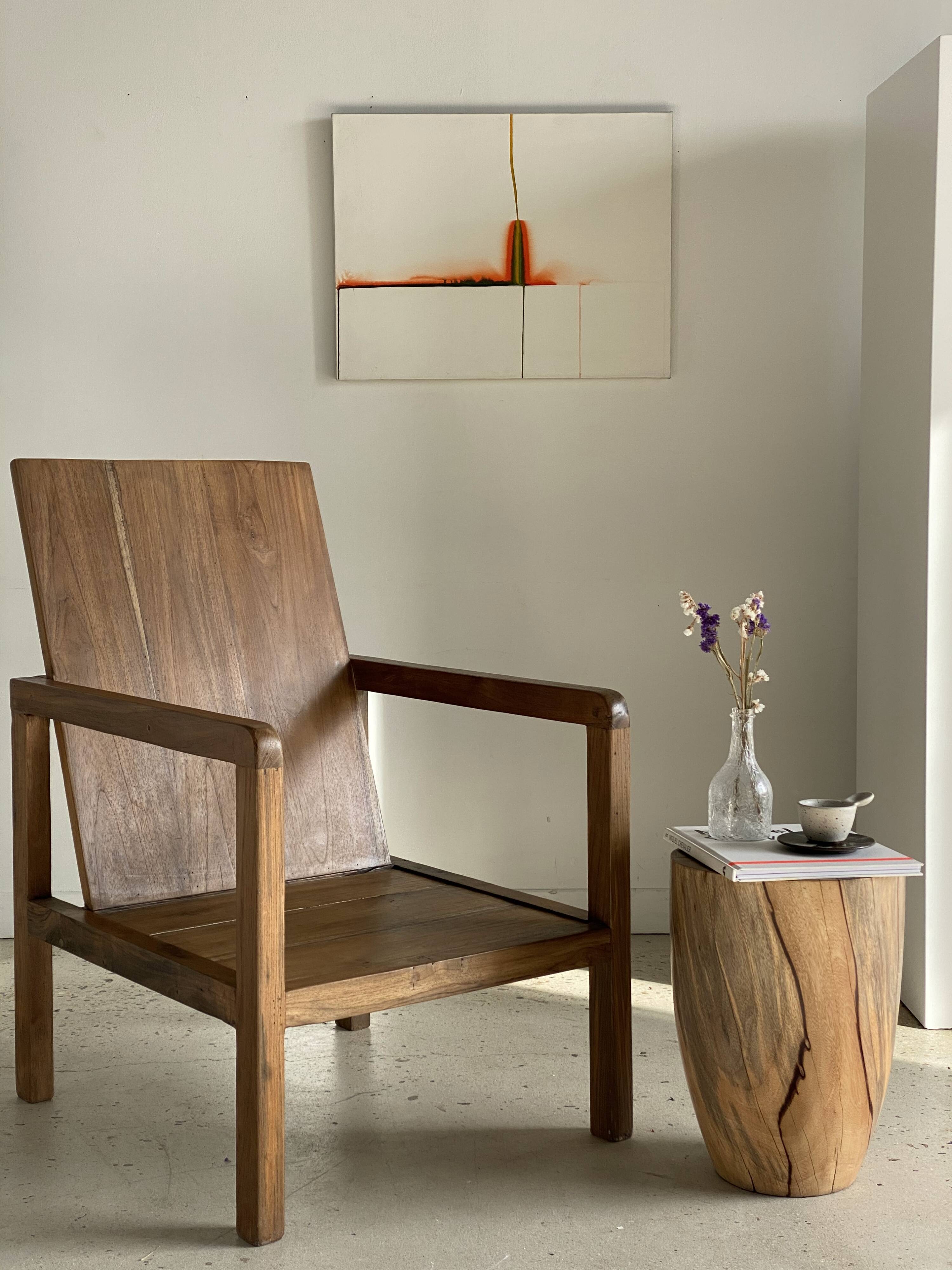 Large armchair in natural wood (teak) with a minimalist design.