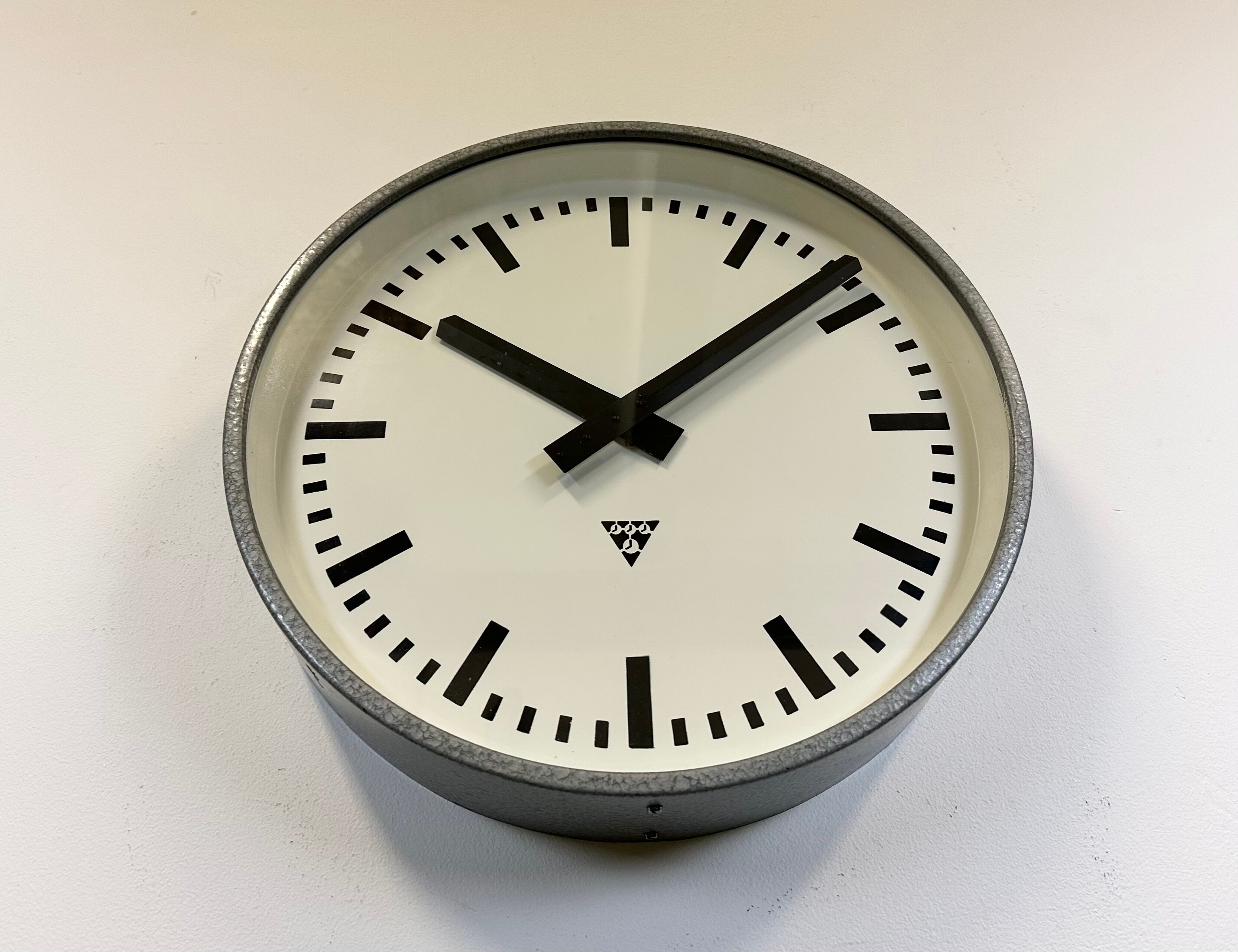 Grey industrial factory wall clock from pragotron, 1960s