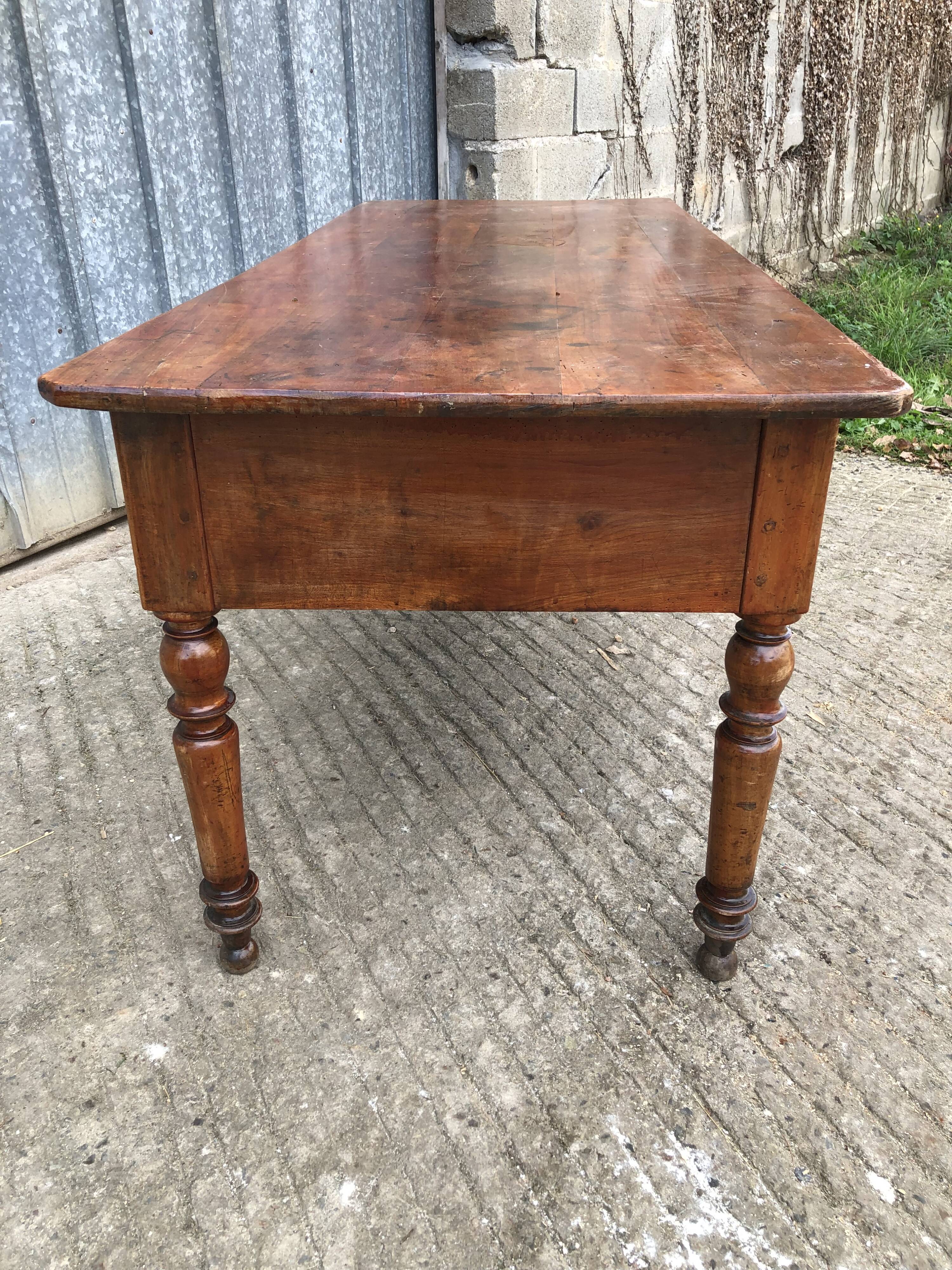 Old farmhouse table in solid cherry wood with 2 front drawers.