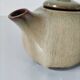Vintage ceramic teapot with a flame design.