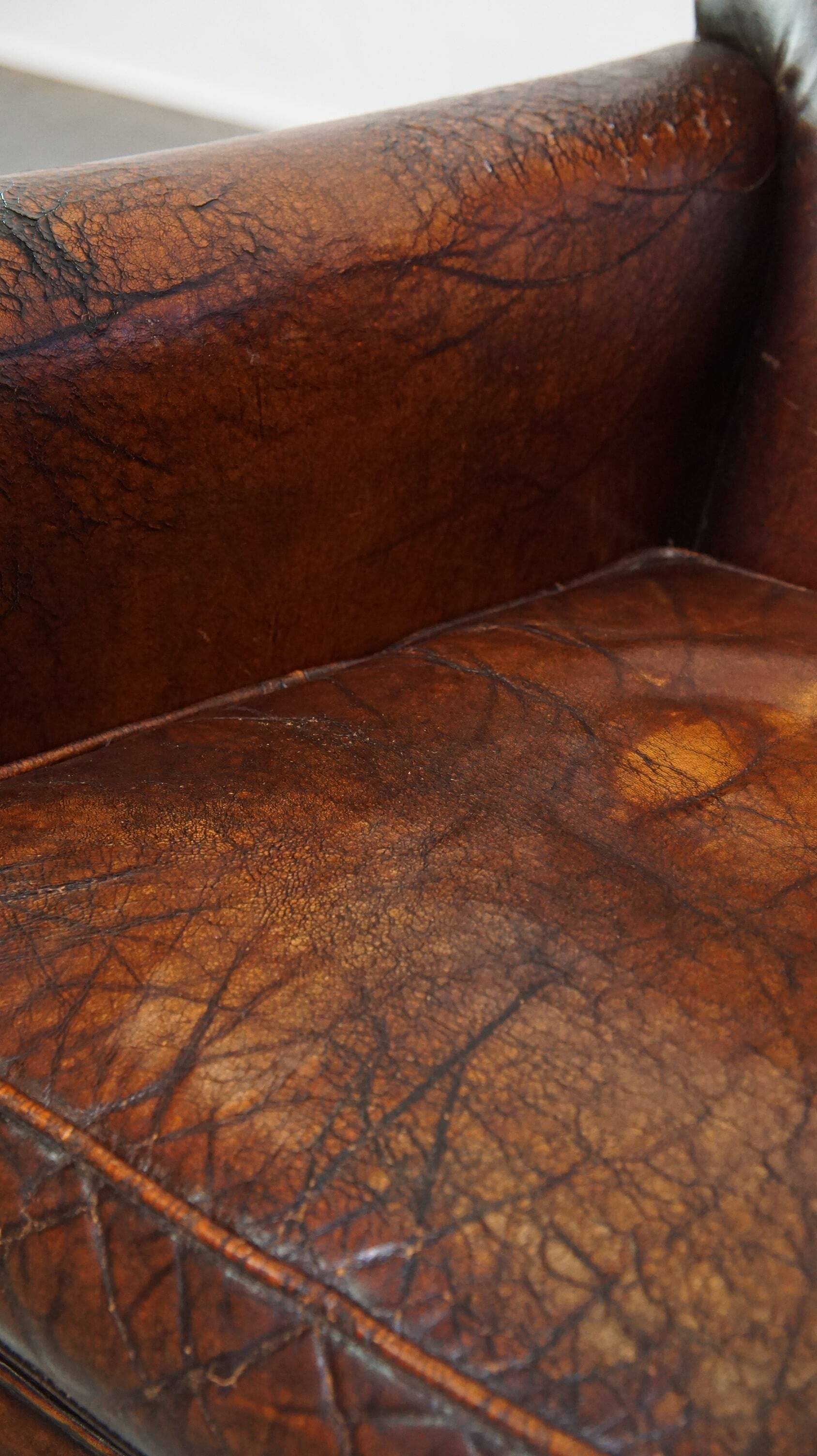 A vintage-style armchair with character, upholstered in beautifully patinated sheepskin.