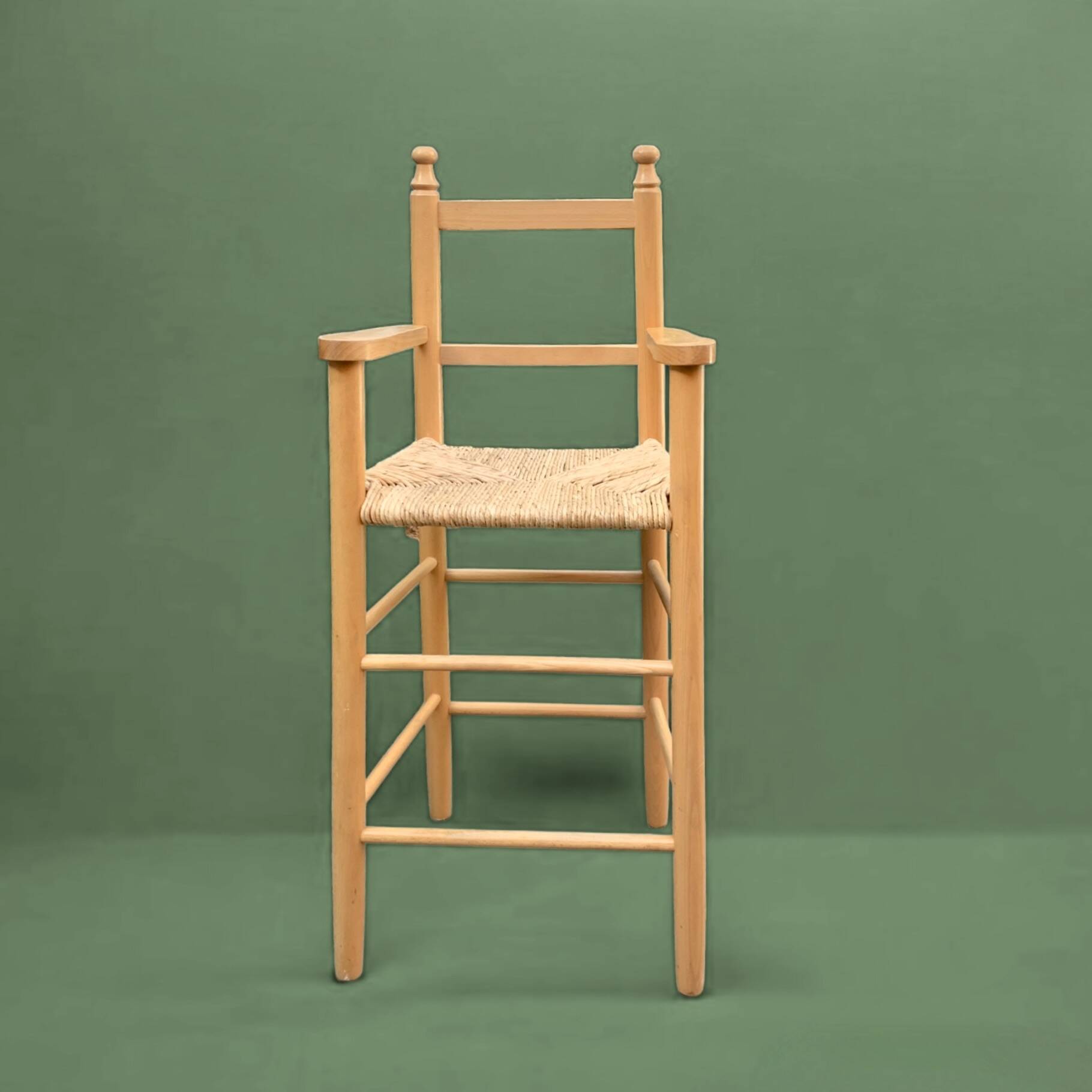 Old wooden and straw high chair for children