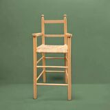 Old wooden and straw high chair for children