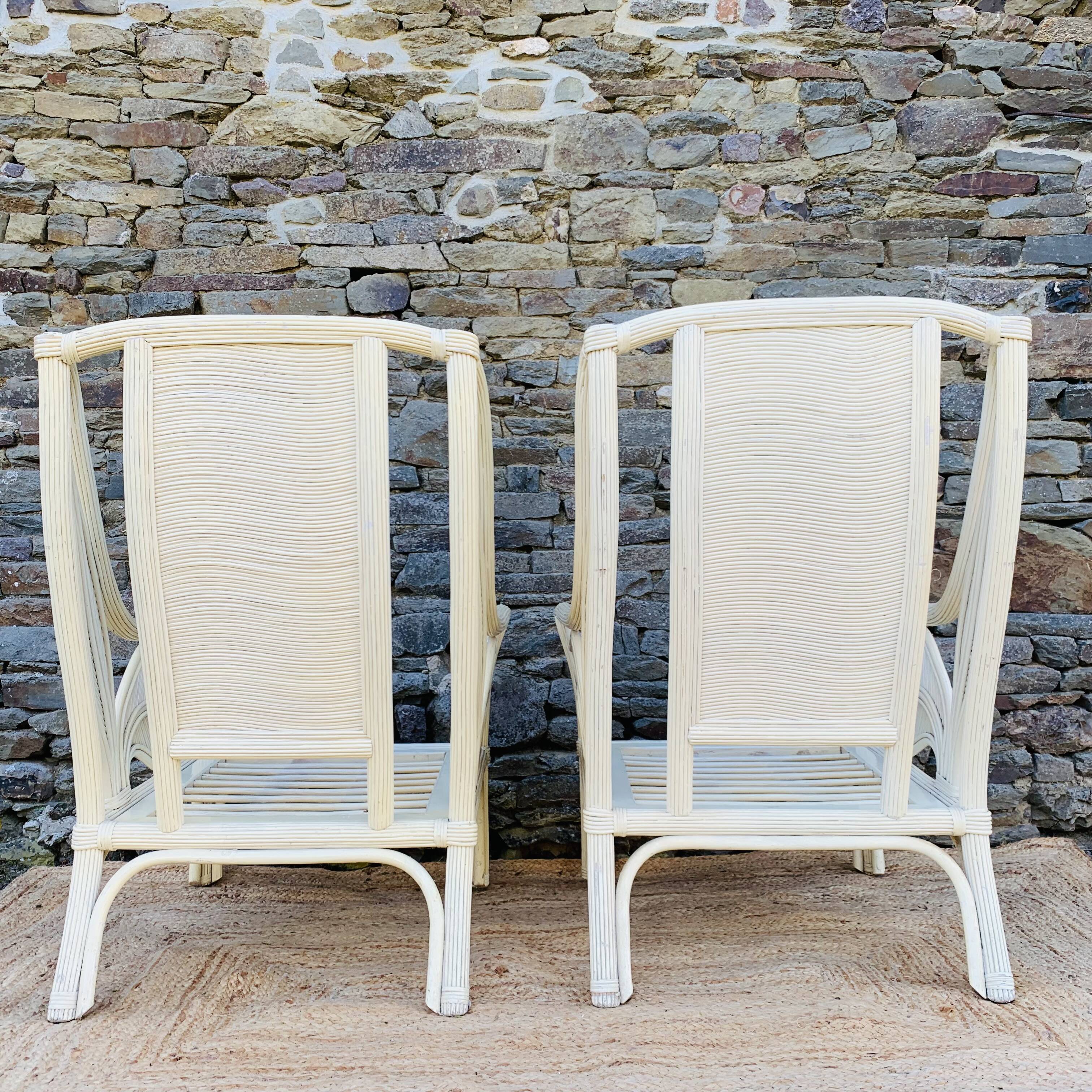 Pair of white rattan armchairs