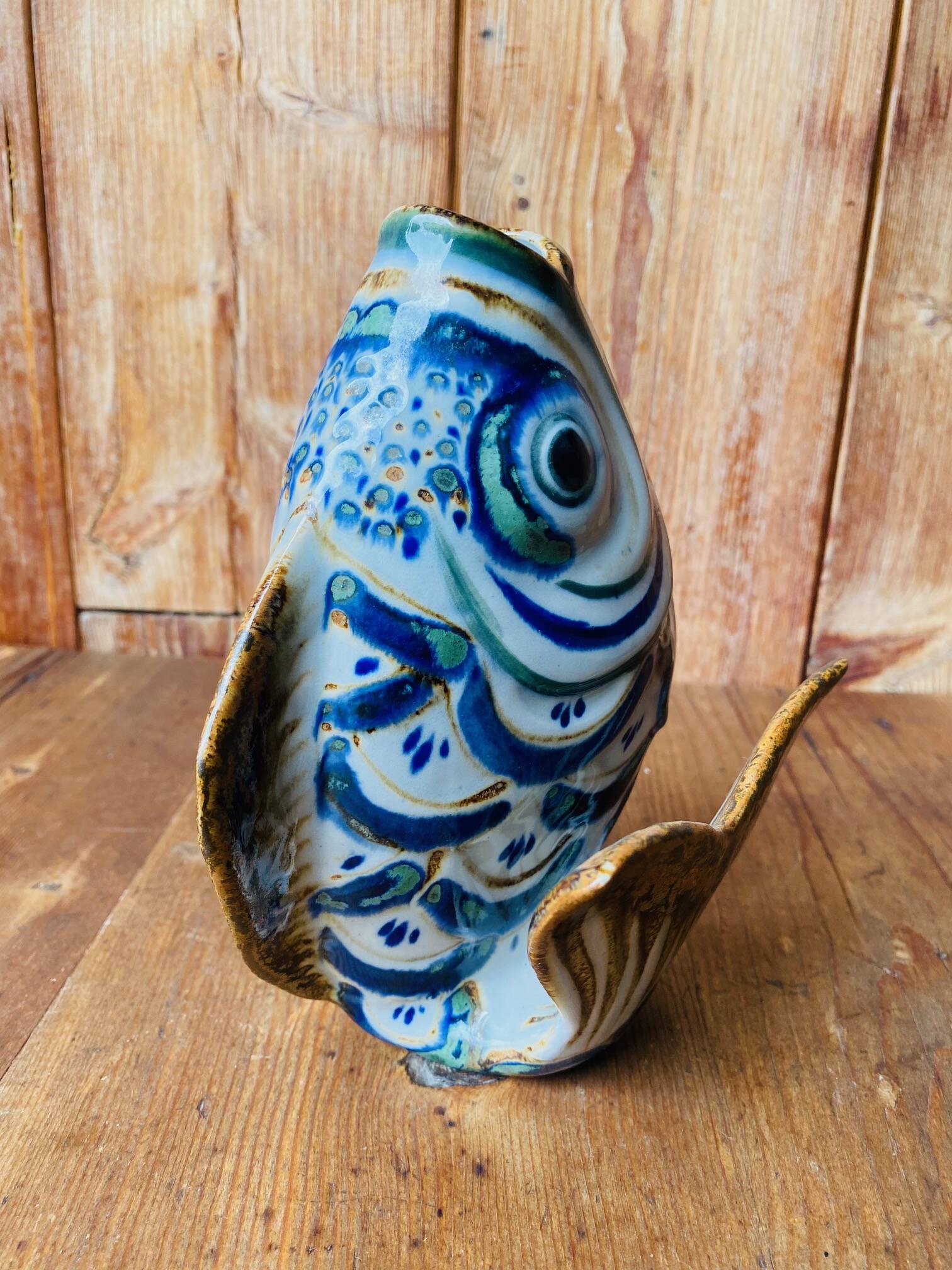Blue ceramic zoomorphic vase in the shape of a poison.