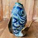Blue ceramic zoomorphic vase in the shape of a poison.