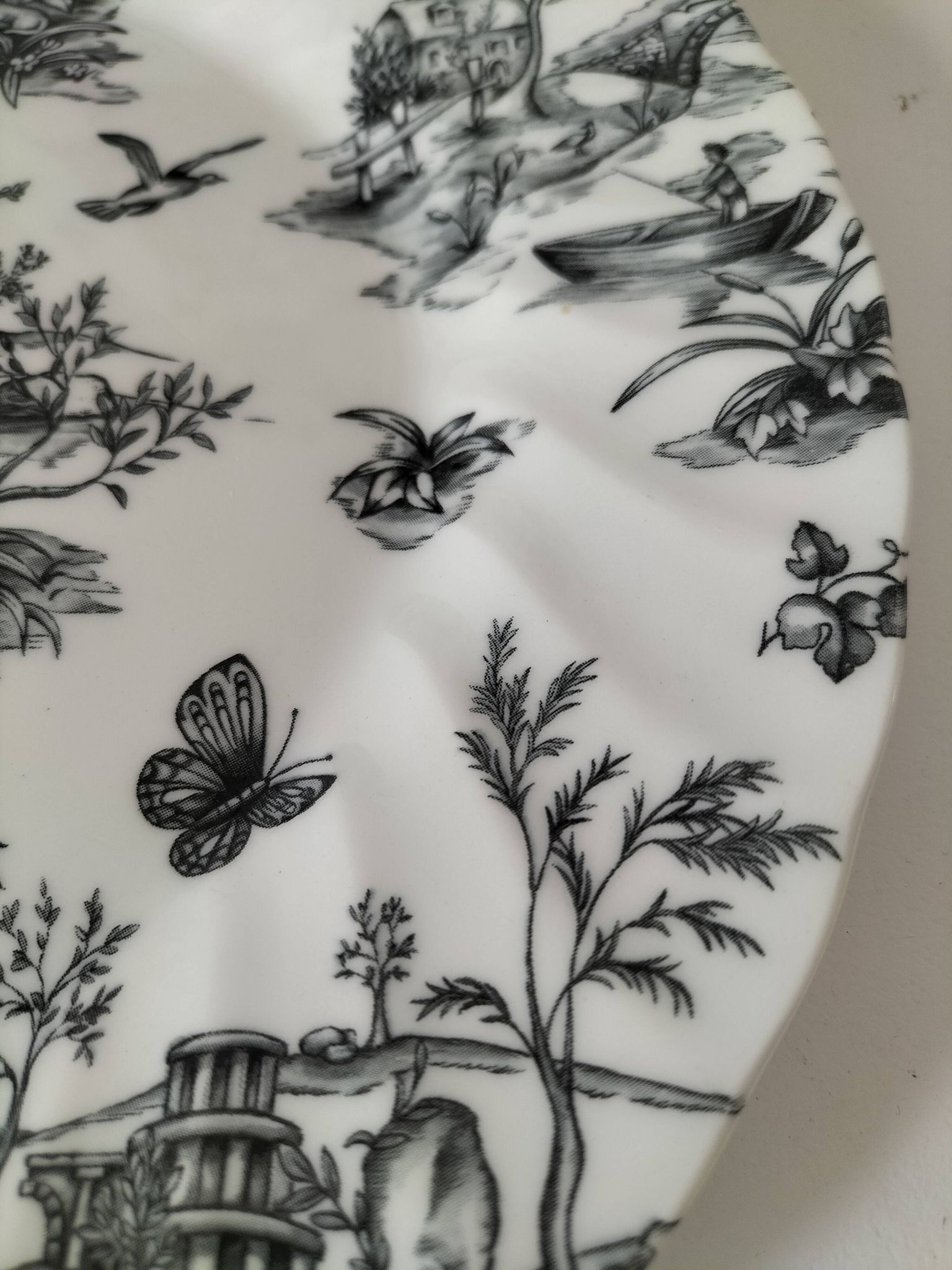 Set of black and white plates in the style of toile de Jouy.