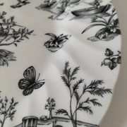 Set of black and white plates in the style of toile de Jouy.