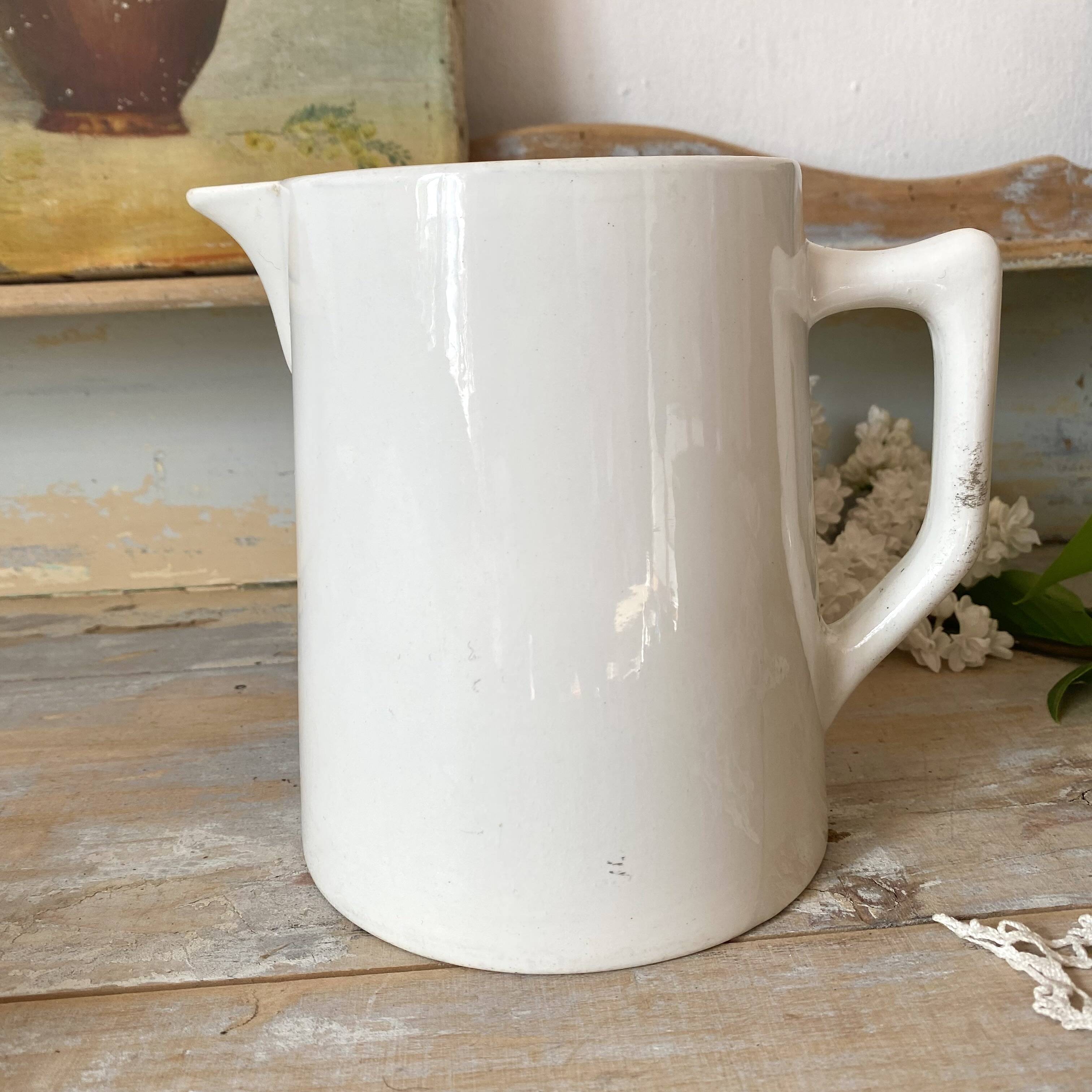Old white earthenware jug