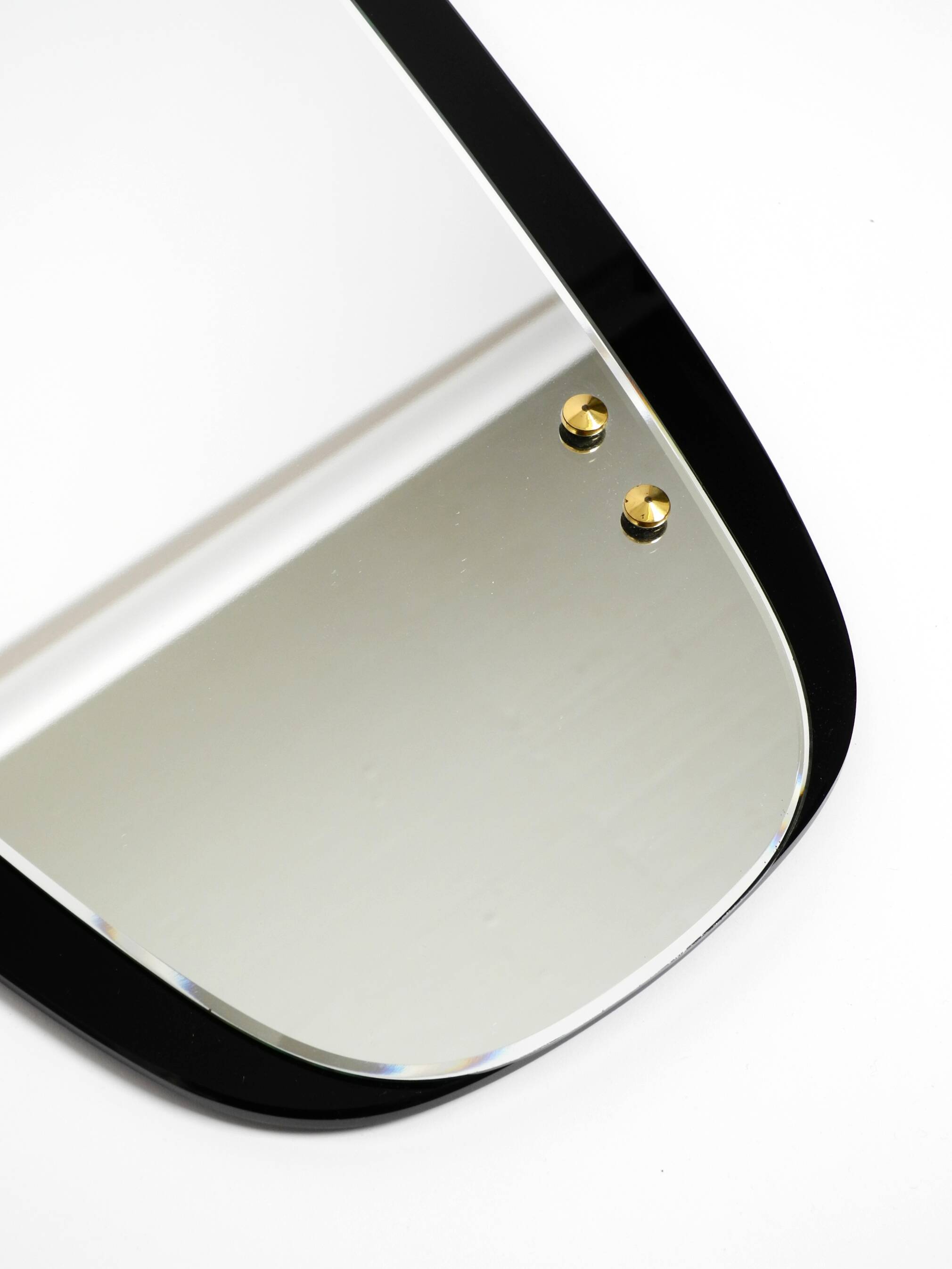 Large Mid Century wall mirror with extraordinary black glass frame