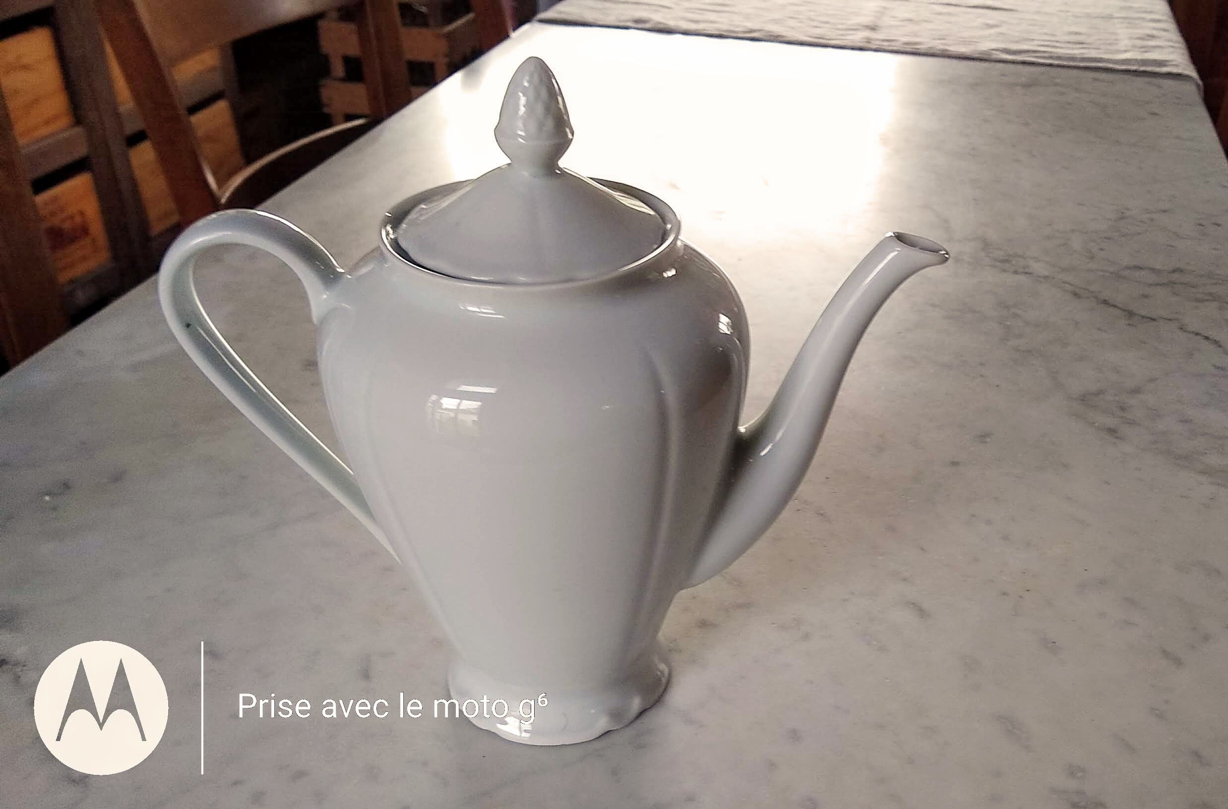 White porcelain teapot with acorn-shaped cap