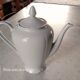 White porcelain teapot with acorn-shaped cap