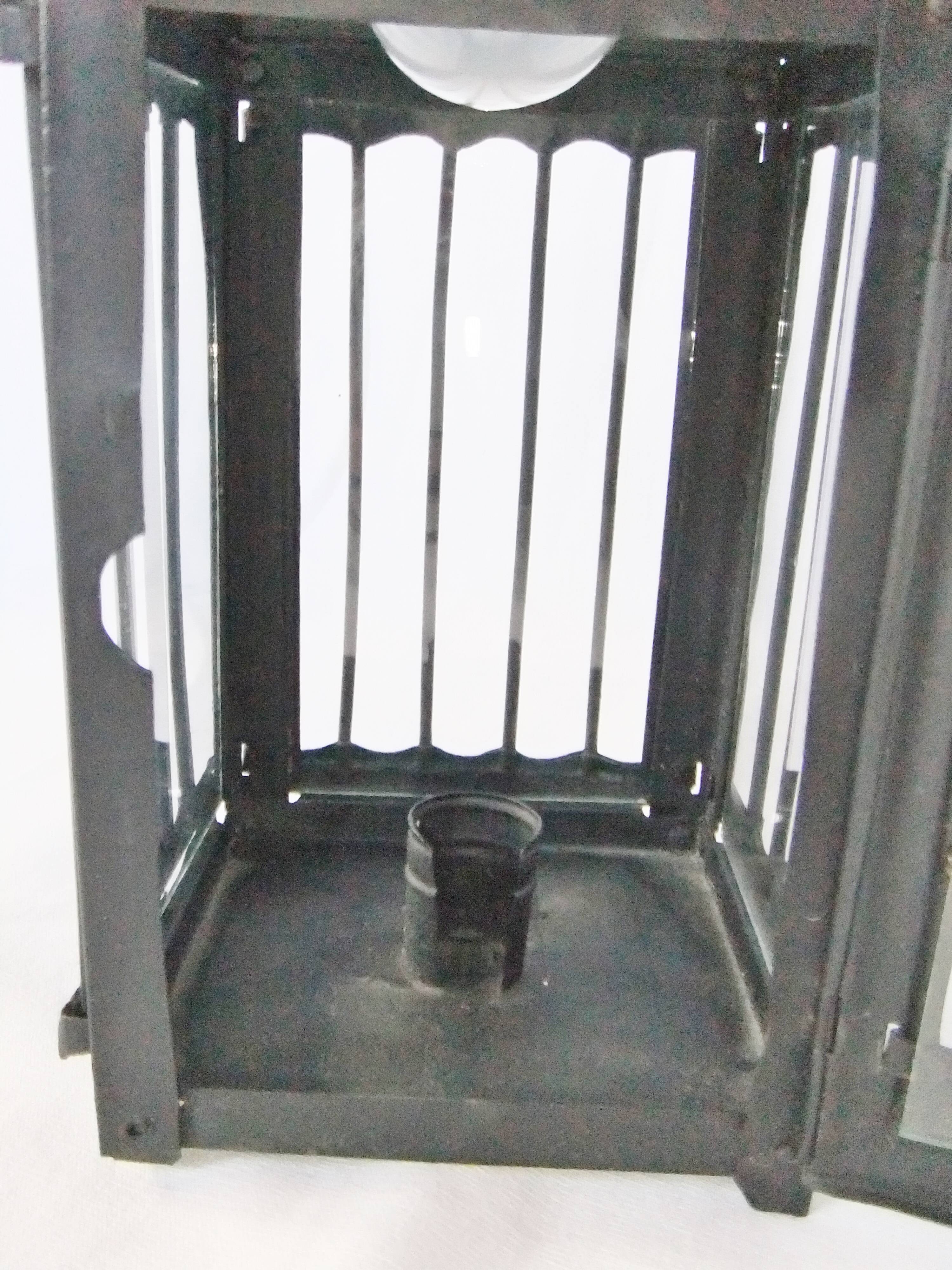 Old chandelier hanging lantern with candle in sheet metal