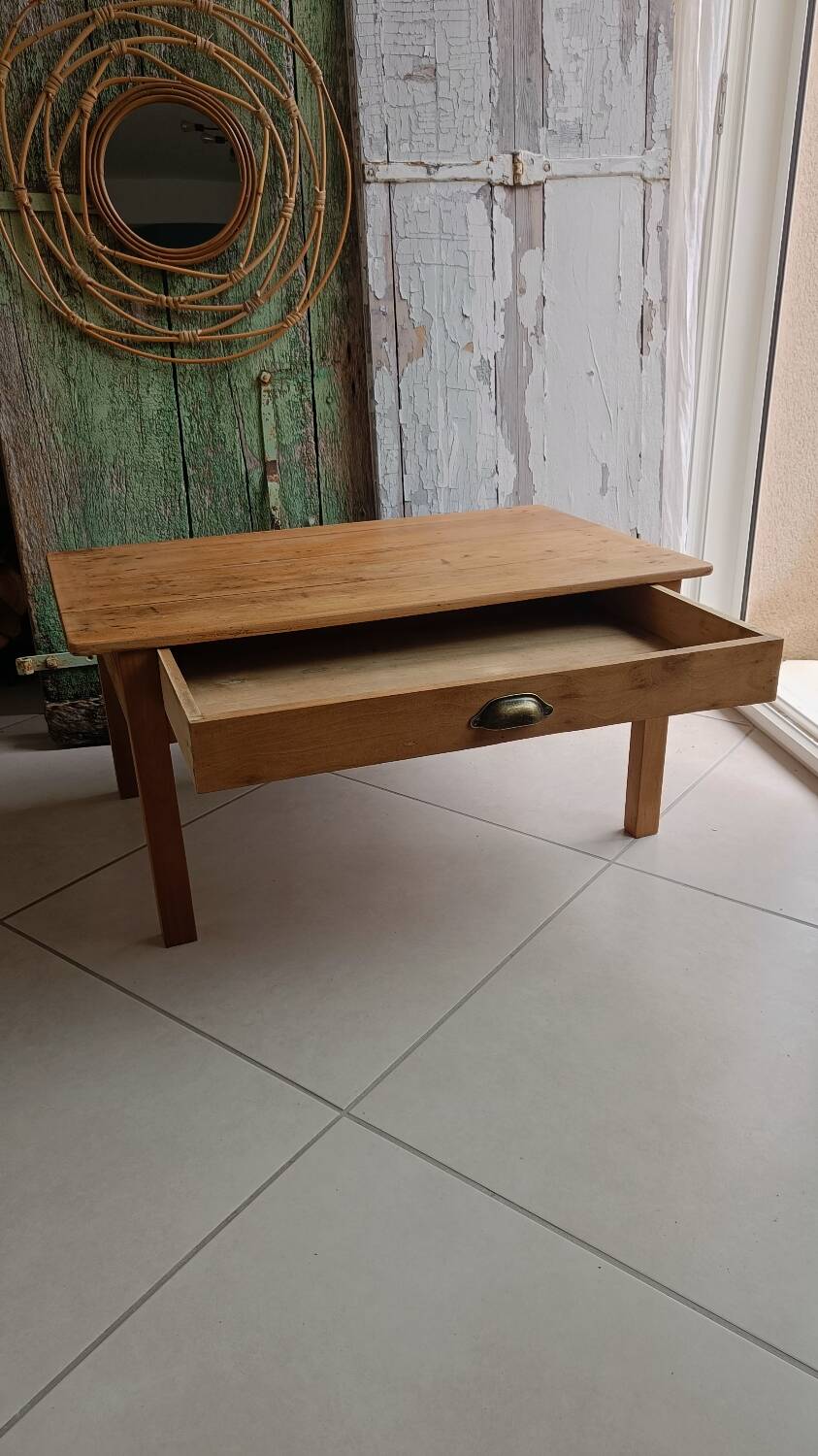 Coffee table with raw wood and a large drawer.