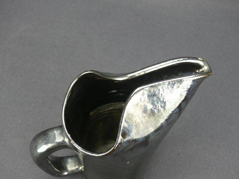 Old Biot, modernist pitcher in iridescent black ceramic.