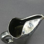 Old Biot, modernist pitcher in iridescent black ceramic.