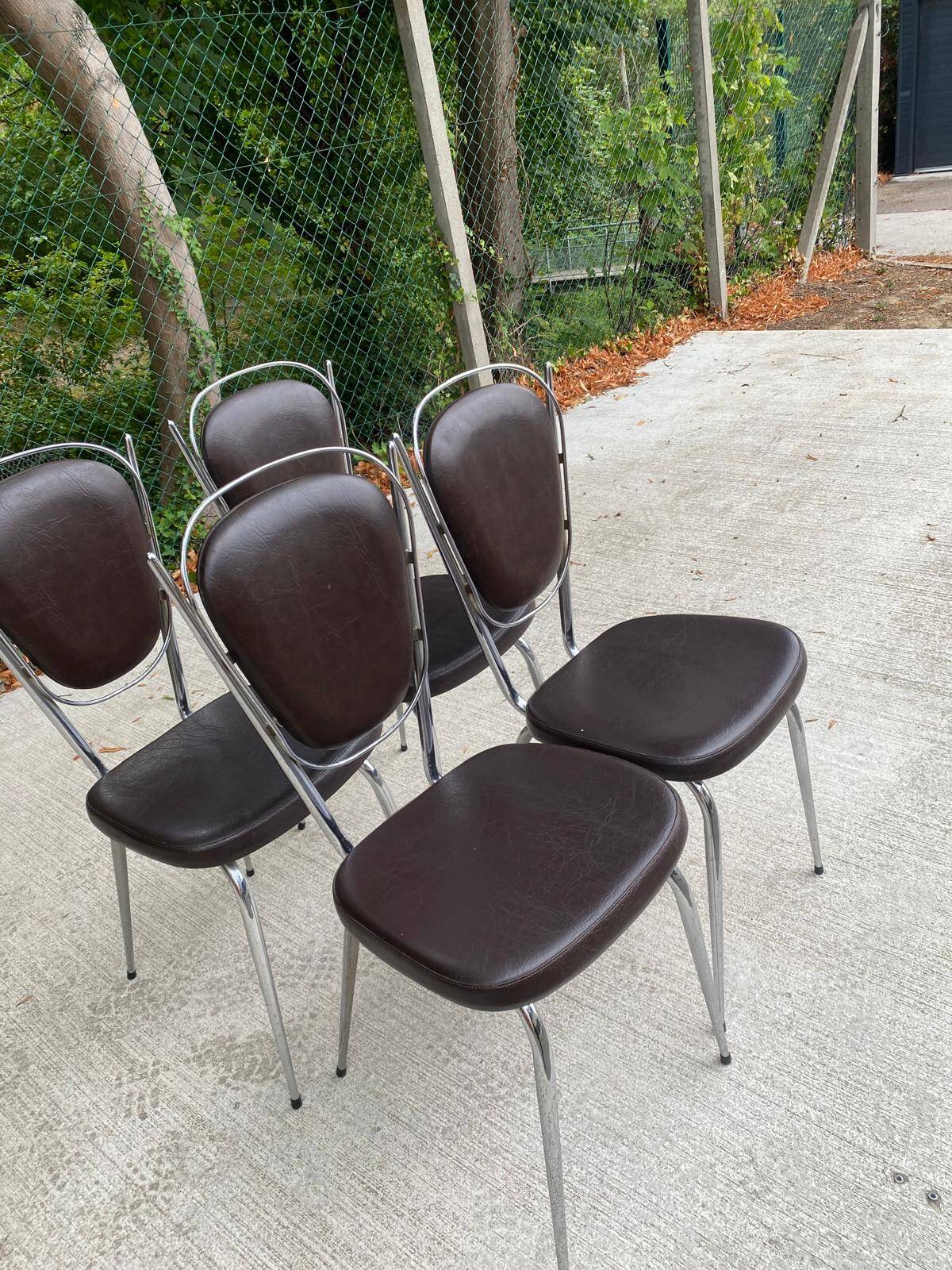 Set of 4 vintage chairs from the 60s/70s in brown faux leather with chrome compass legs.