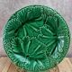 Set of 2 green earthenware dessert plates with vine decoration.