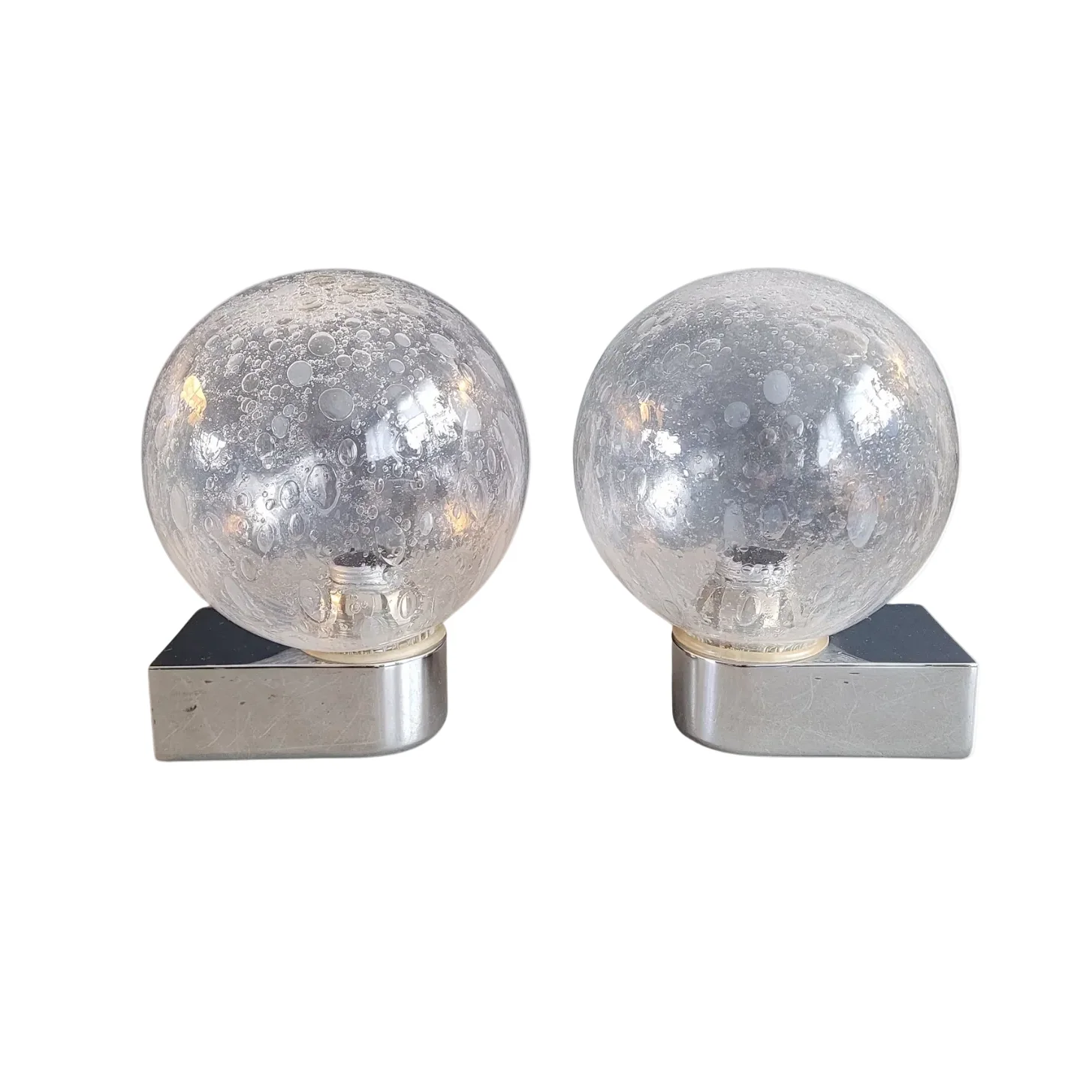 Pair of vintage wall lights in chrome metal with bubbled glass globes.
