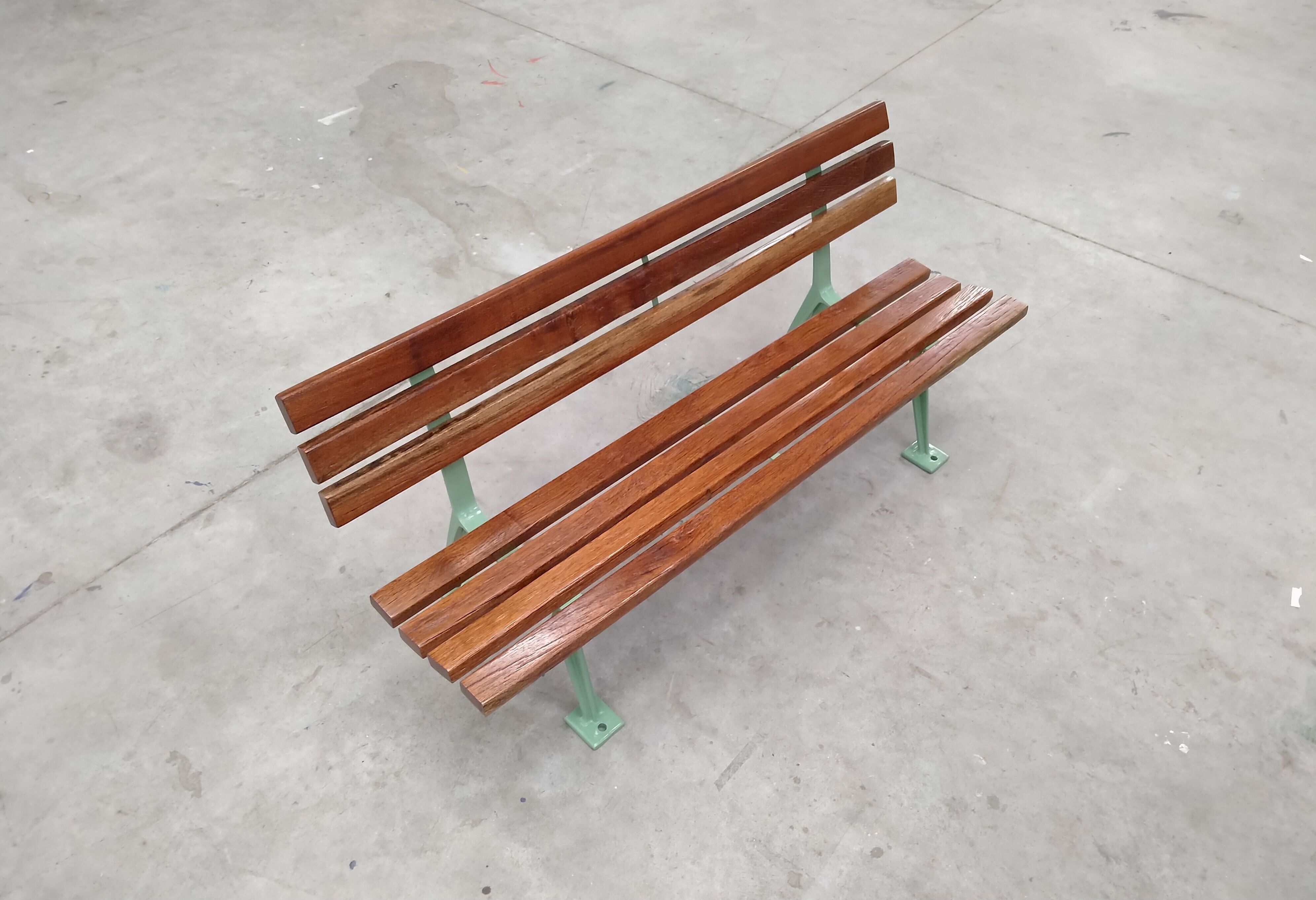 Restored and varnished garden bench in hardwood and olive green metal
