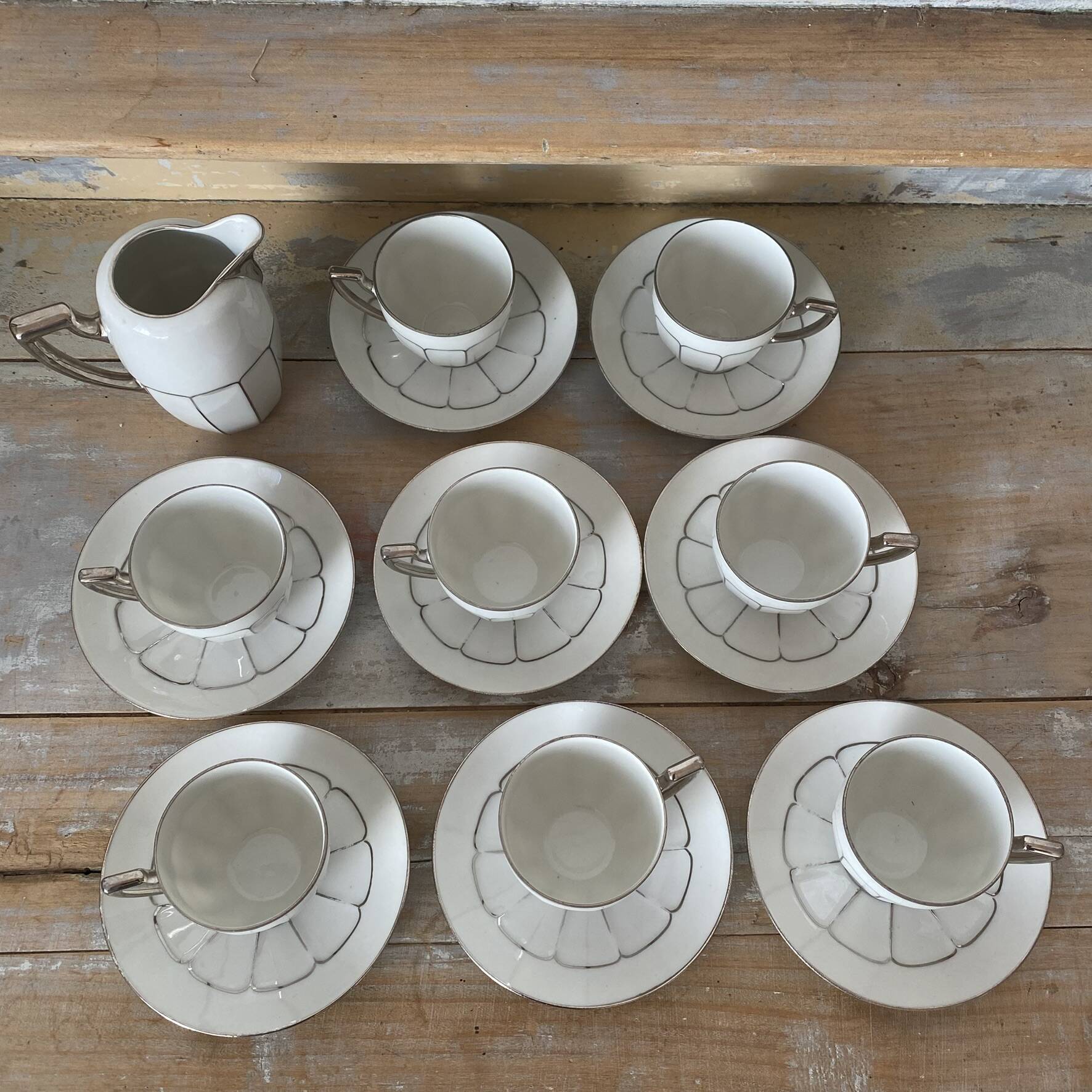 White and silver Limoges porcelain coffee cups and saucers.
