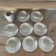 White and silver Limoges porcelain coffee cups and saucers.