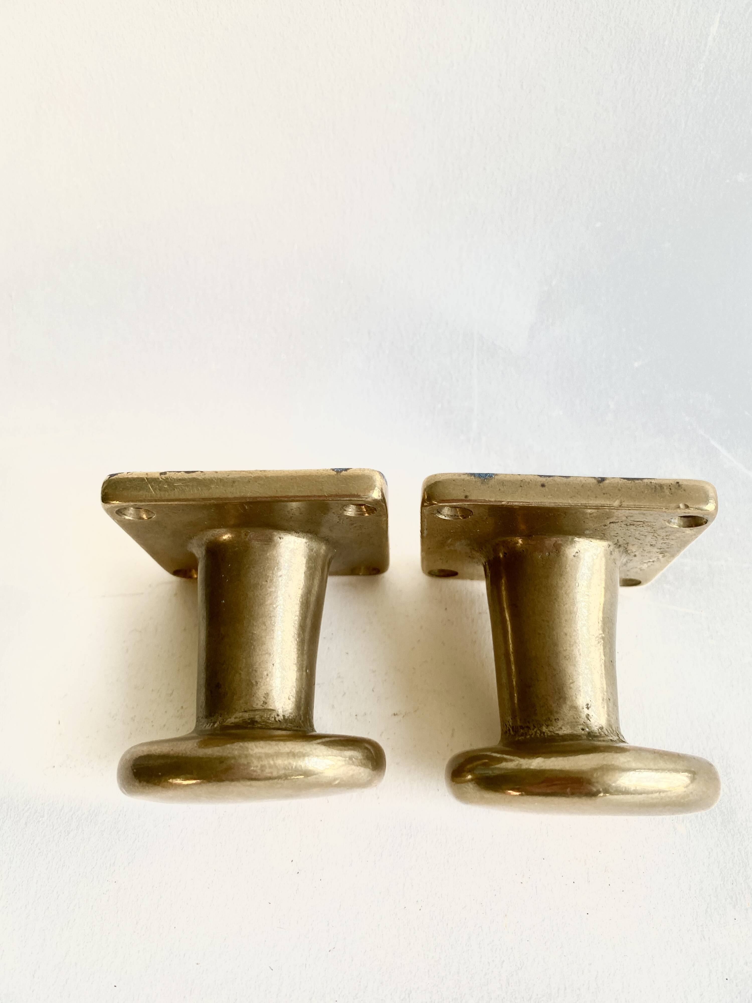 Pair of golden cast iron hooks