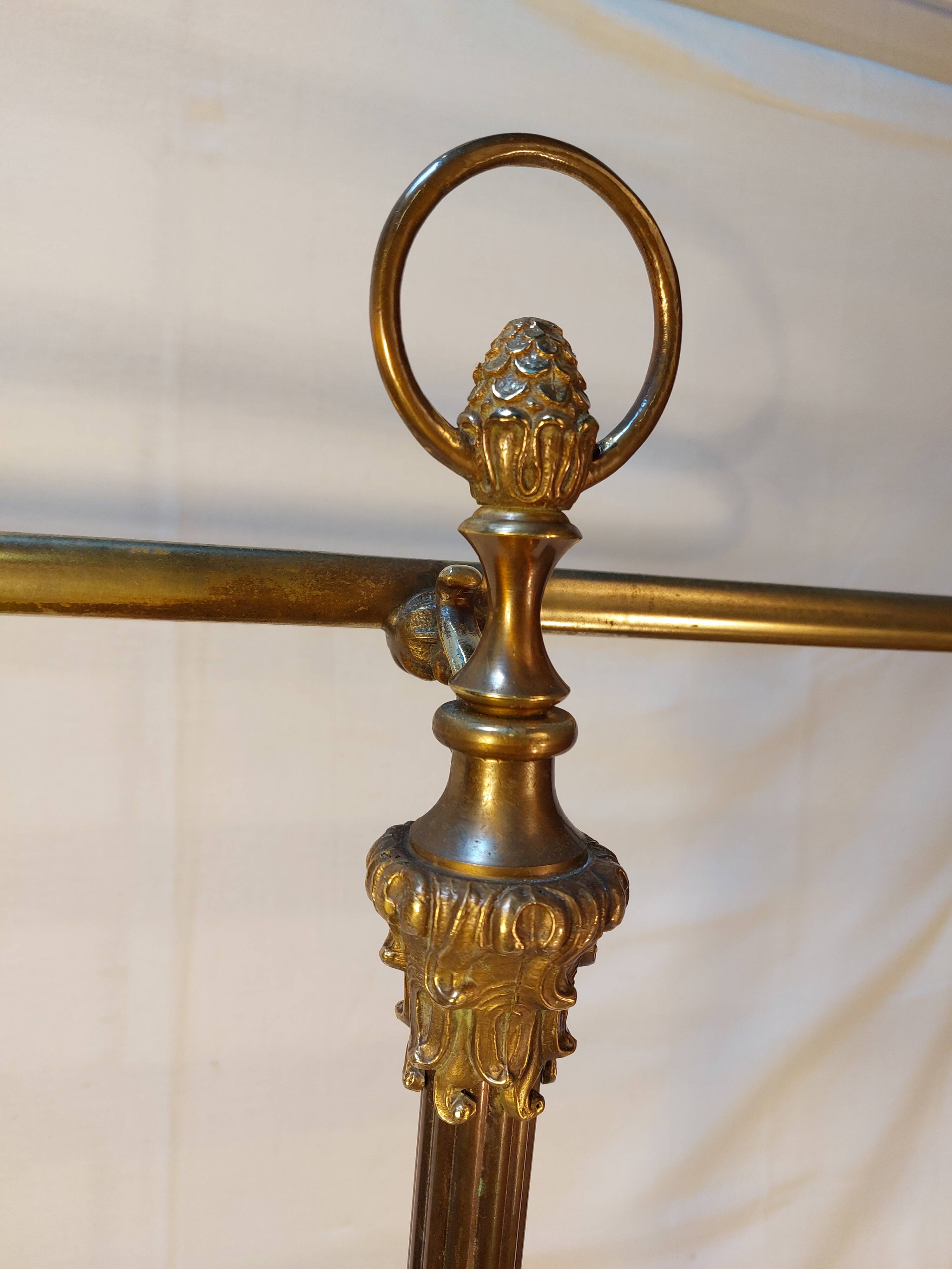 Old golden brass towel rack on baroque style foot