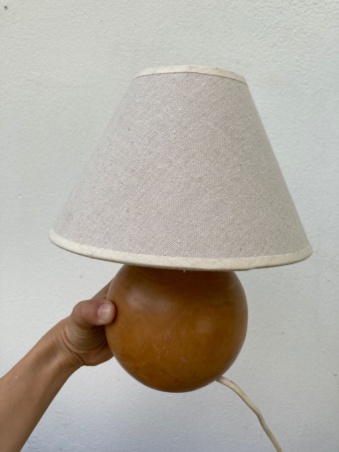 Wooden ball bedside lamp and beige lampshade