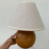Wooden ball bedside lamp and beige lampshade