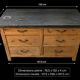 Old wooden workshop furniture with a stone top.