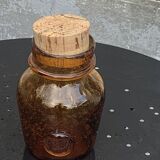 Blown and bubbled glass jar in the style of Biot glassworks, amber color