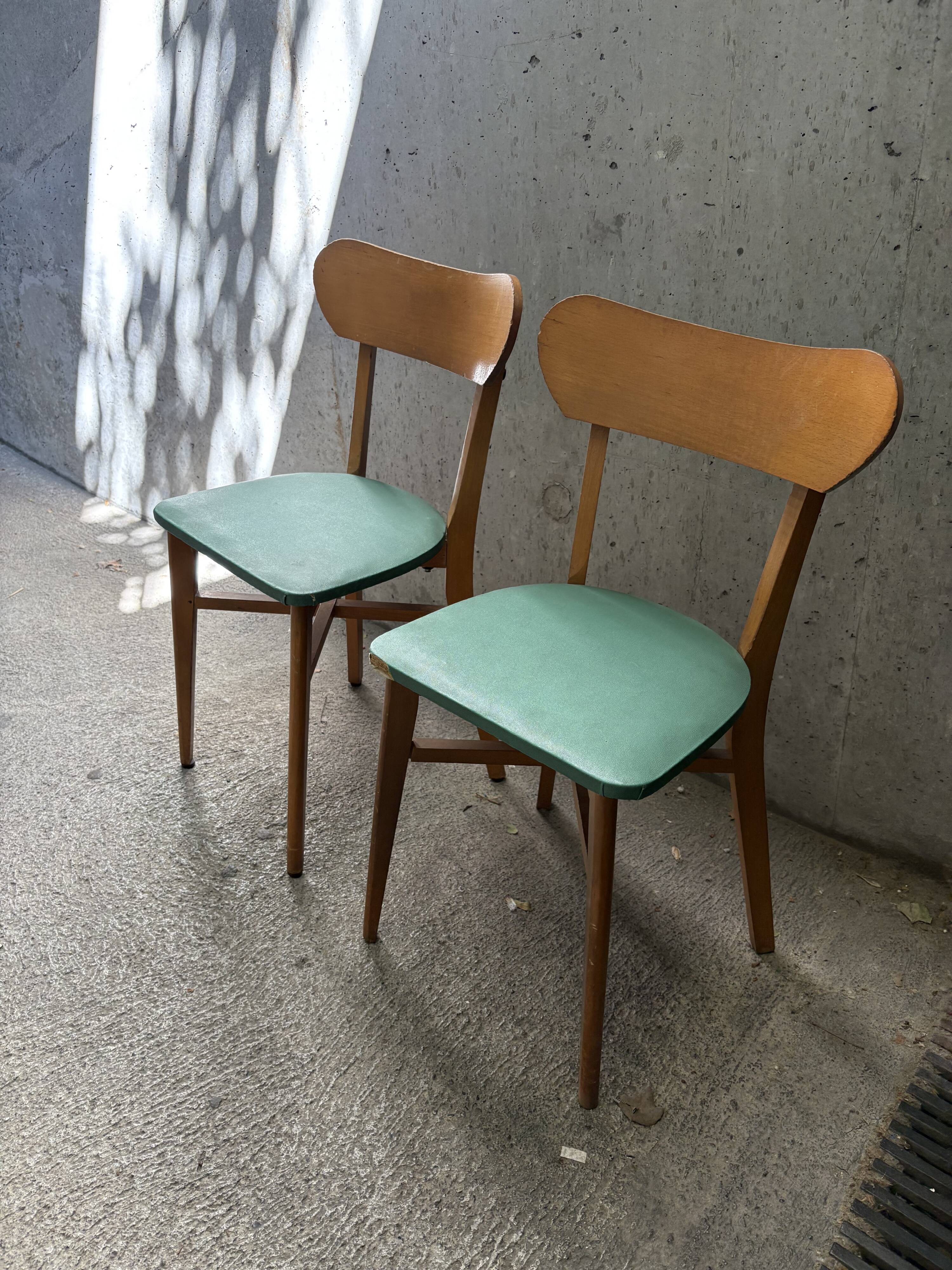 Pair of green faux leather chairs with vintage wood from the 60s and 70s.
