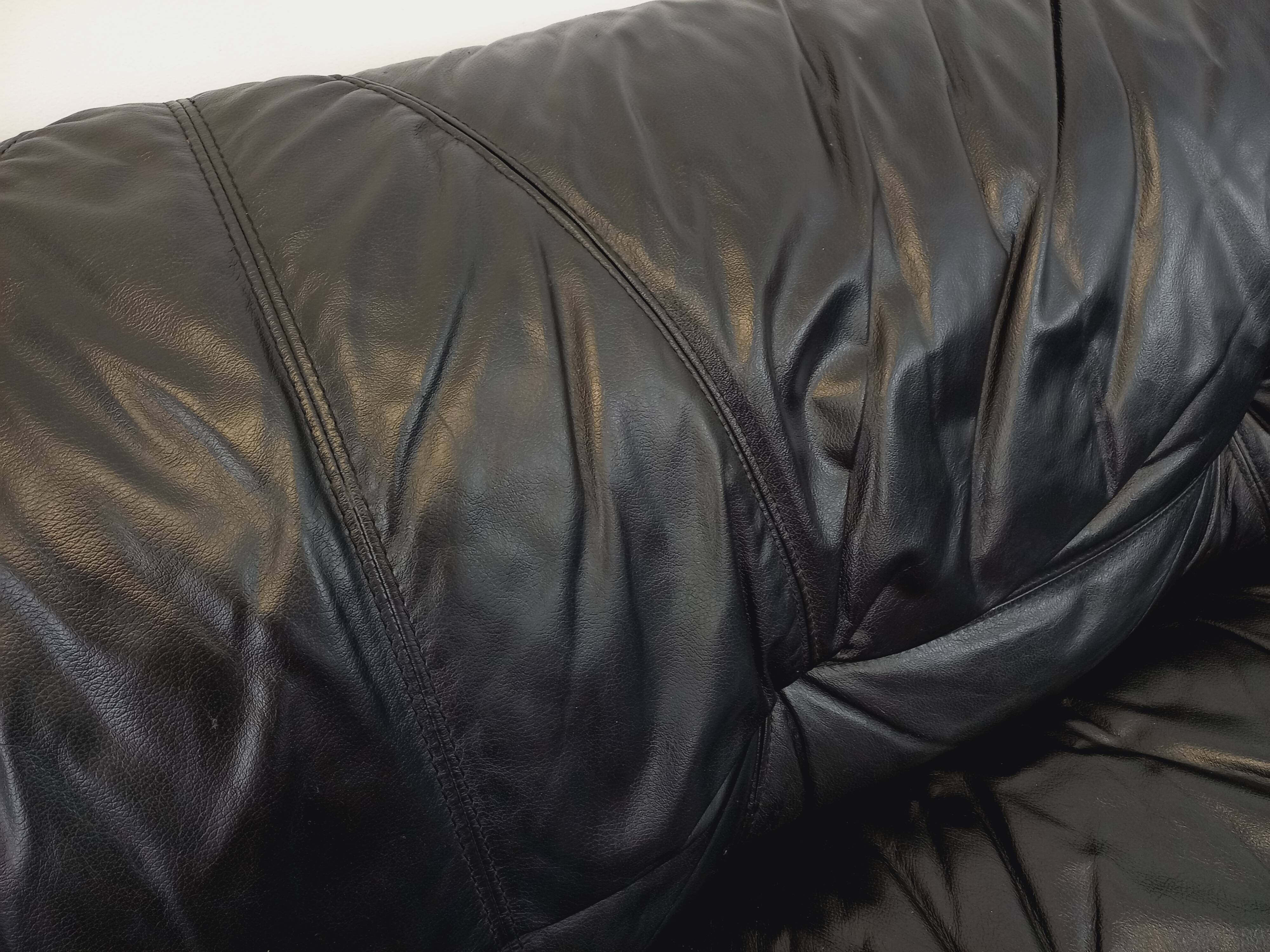 Vintage corner sofa composed of 3 modules in black leather with integrated bed.