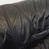 Vintage corner sofa composed of 3 modules in black leather with integrated bed.