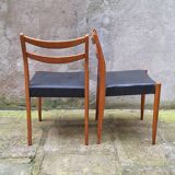 Pair of Scandinavian style chairs in wood and faux leather.