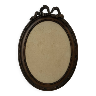 Old oval frame with knot