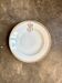 Assiette creuse en porcelaine dorée monogrammée "F"