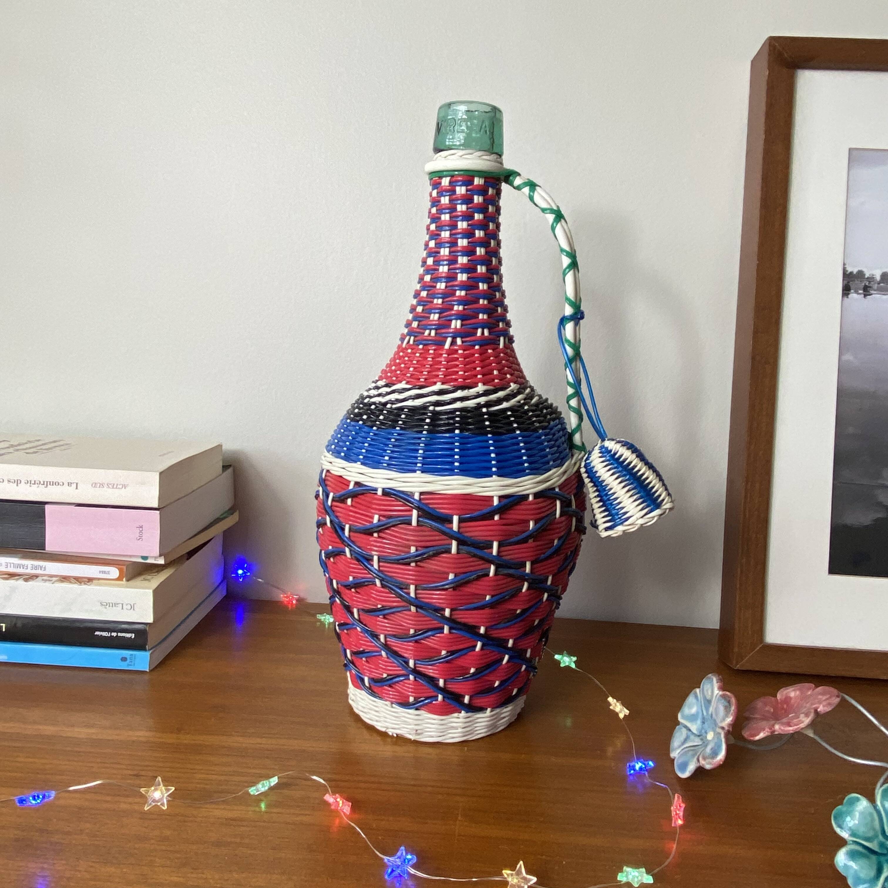 Old glass bottle and vintage scoubidou plastic weaving