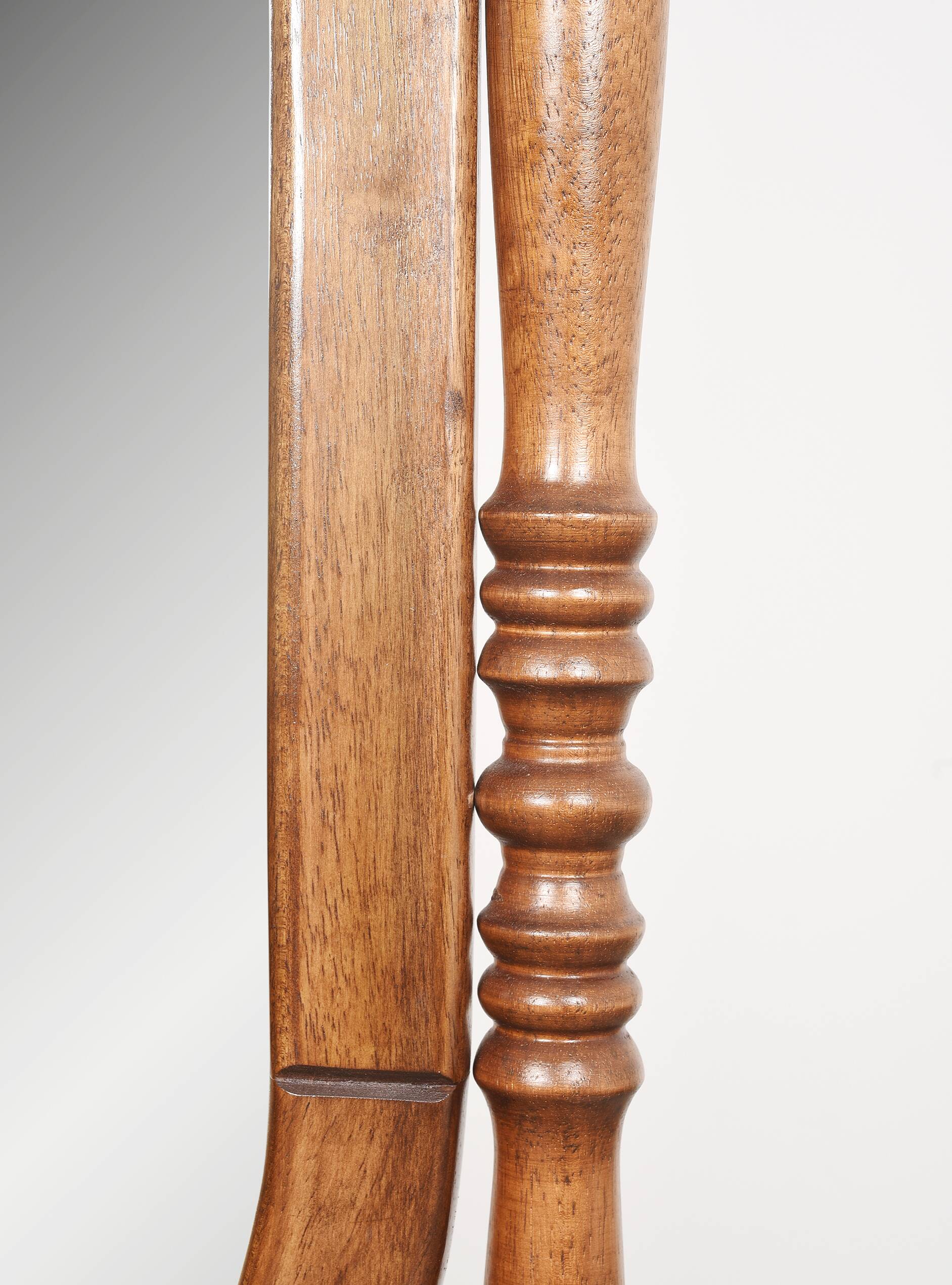 Large psychic mirror on legs with pivoting oval frame.