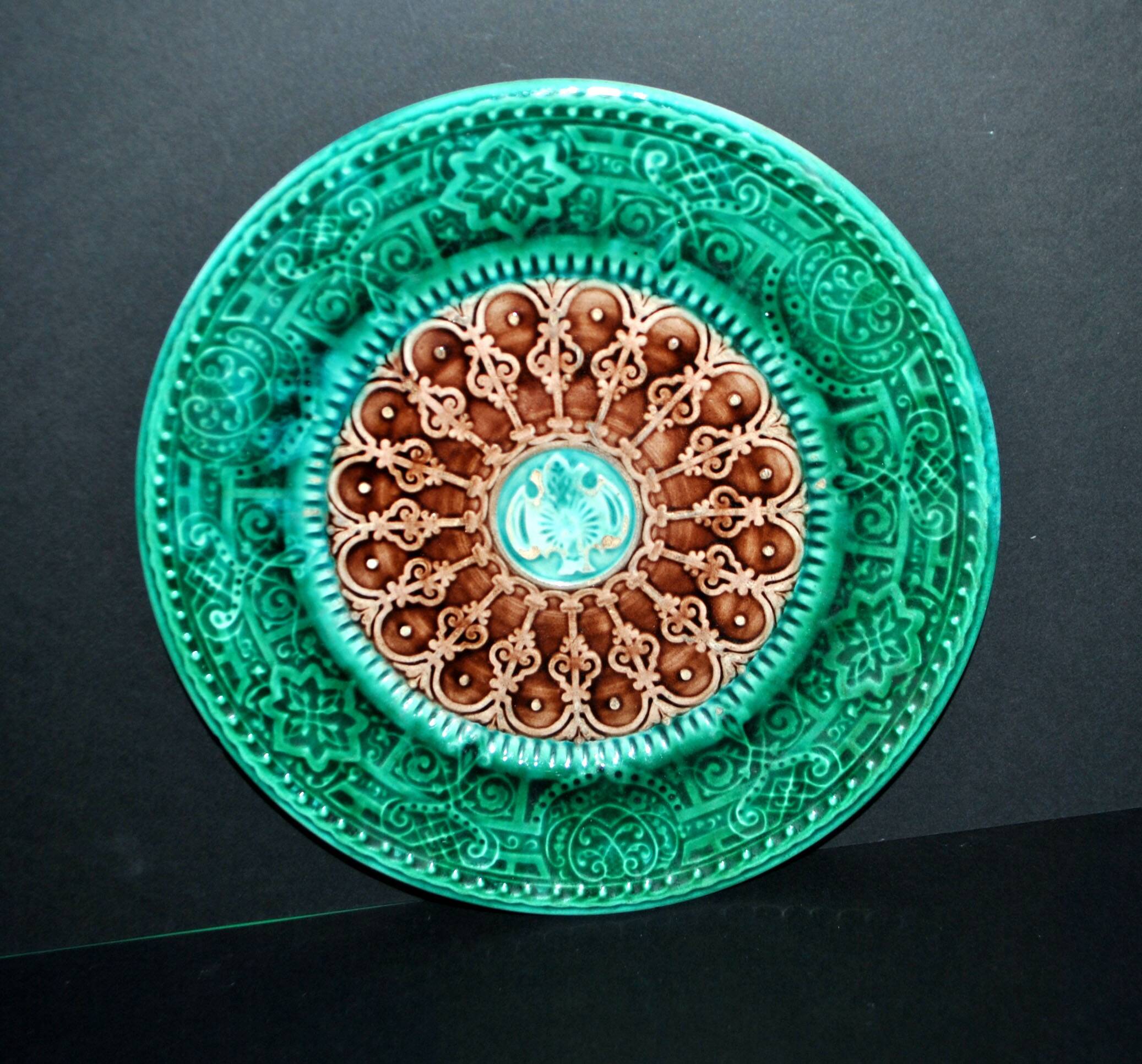 Antique plate in turquoise brown green slip with arabesque decoration