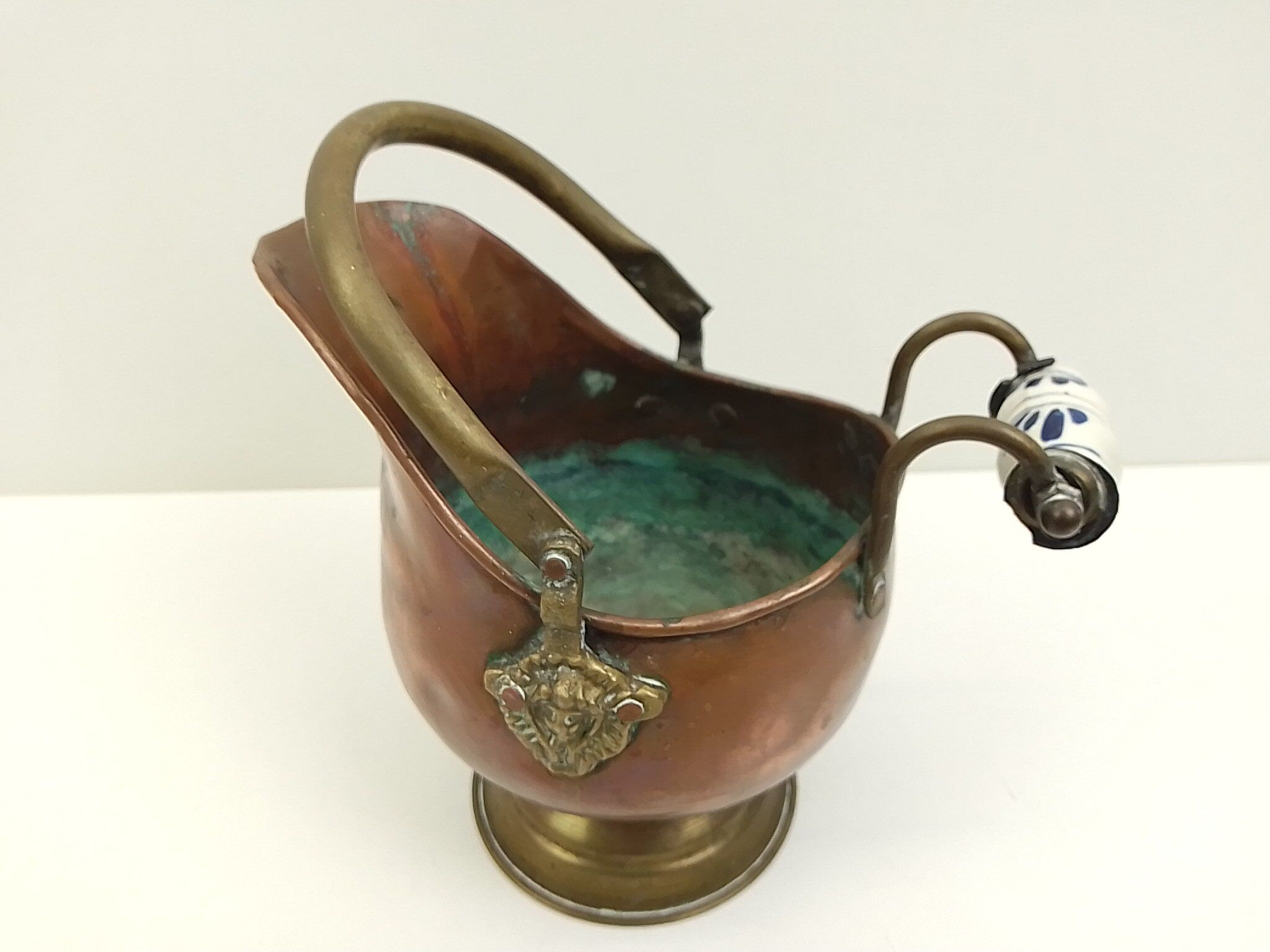 Copper pot cover and a pitcher-style brass handle